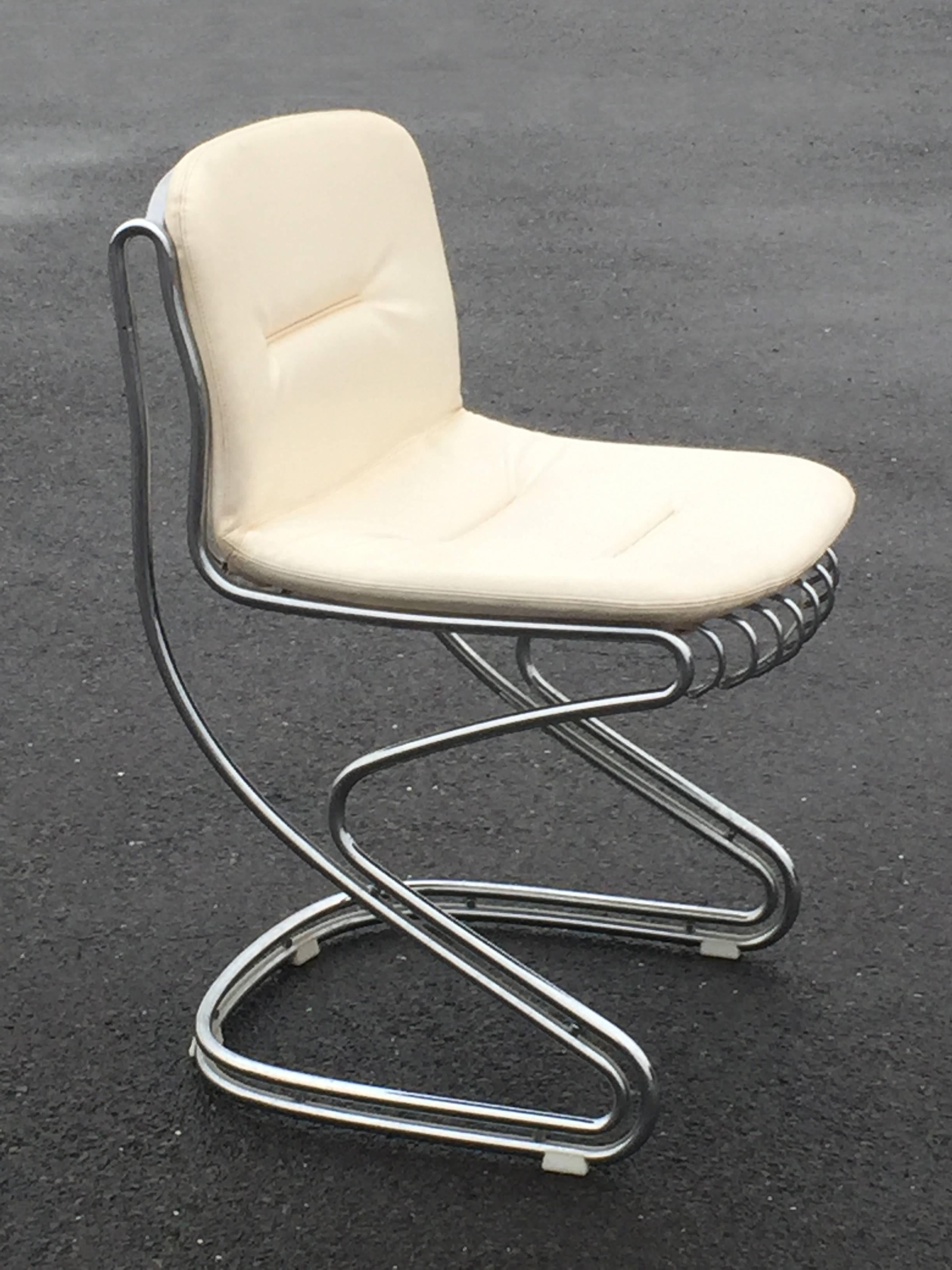 Four chrome and white faux leather side chairs by Italian design legend Gastone Rinaldi for Rima. Original white leather like upholstery is in very good condition and the sculptural sleek tubular chrome bases are stunning.
Seat height 19.5