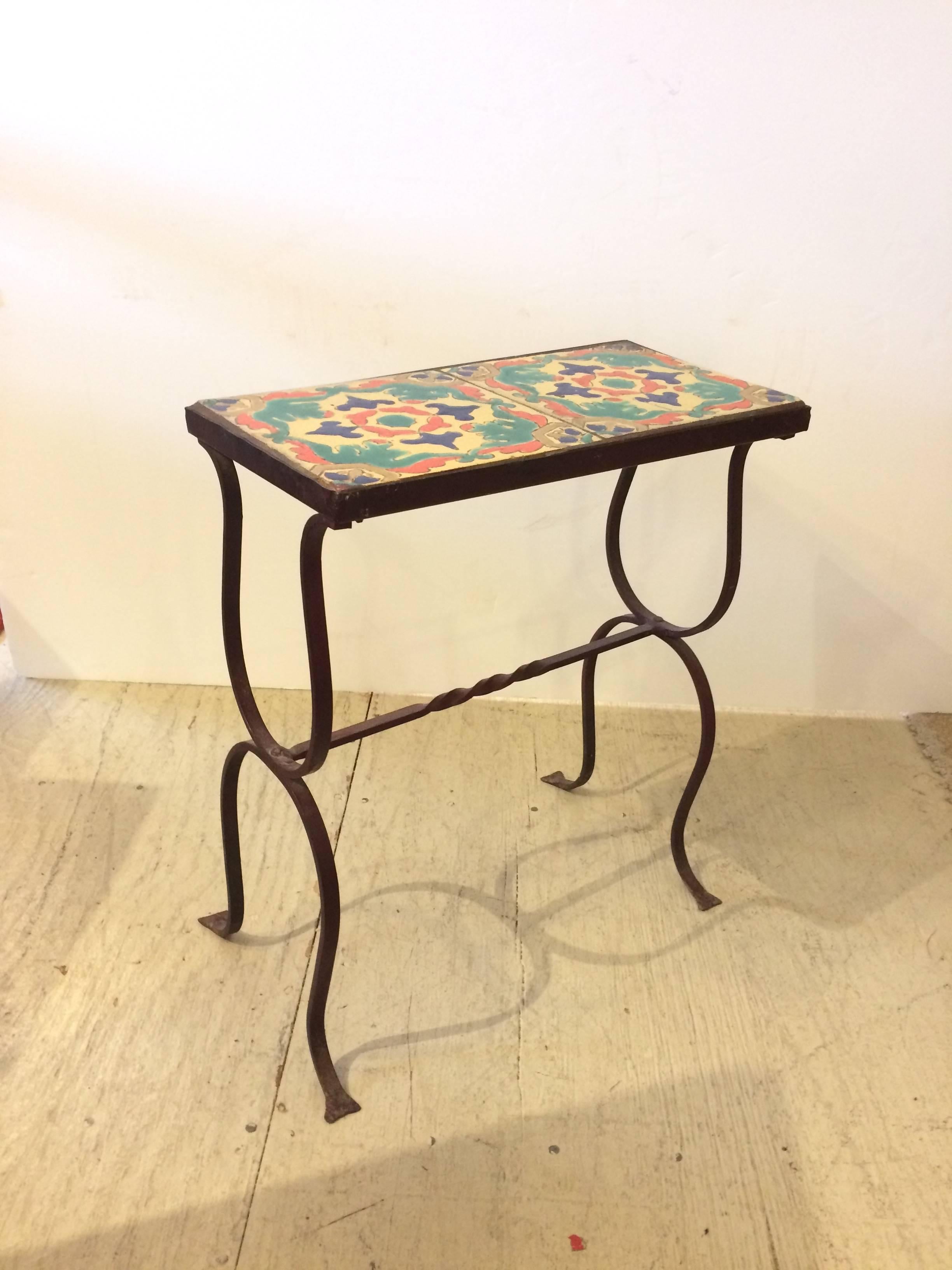 Wonderful vintage Arts & Crafts little side or drinks table having elegant curved wrought iron base and artisan crafted tile-top.