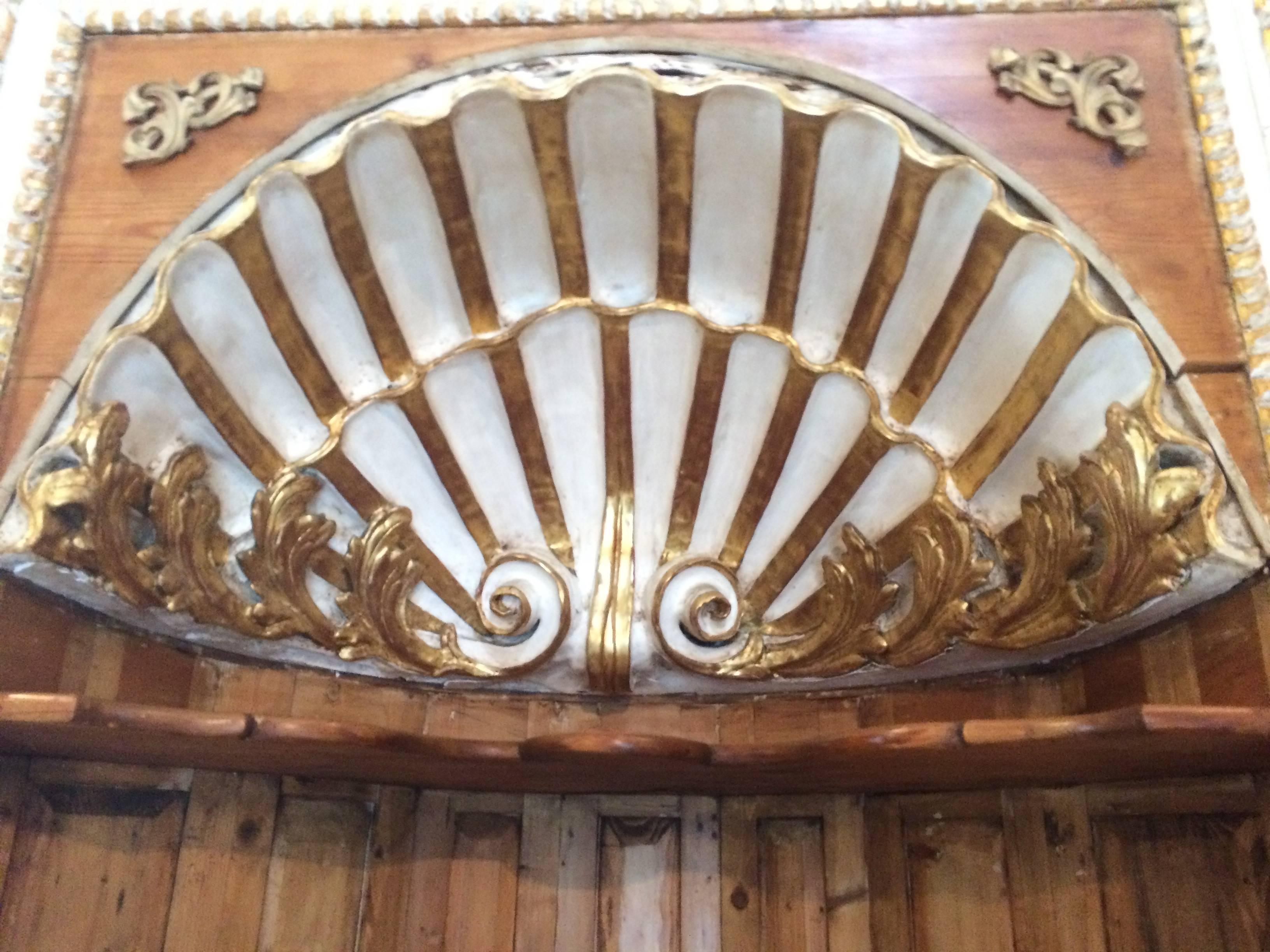Stunning Louis XIV curved corner cabinets, having gorgeous carved wood interior scallop shell at the top with white cream paint and gold leaf, beautiful workmanship, two shelves and panel doors at the bottom that reveal more storage. Measures: The