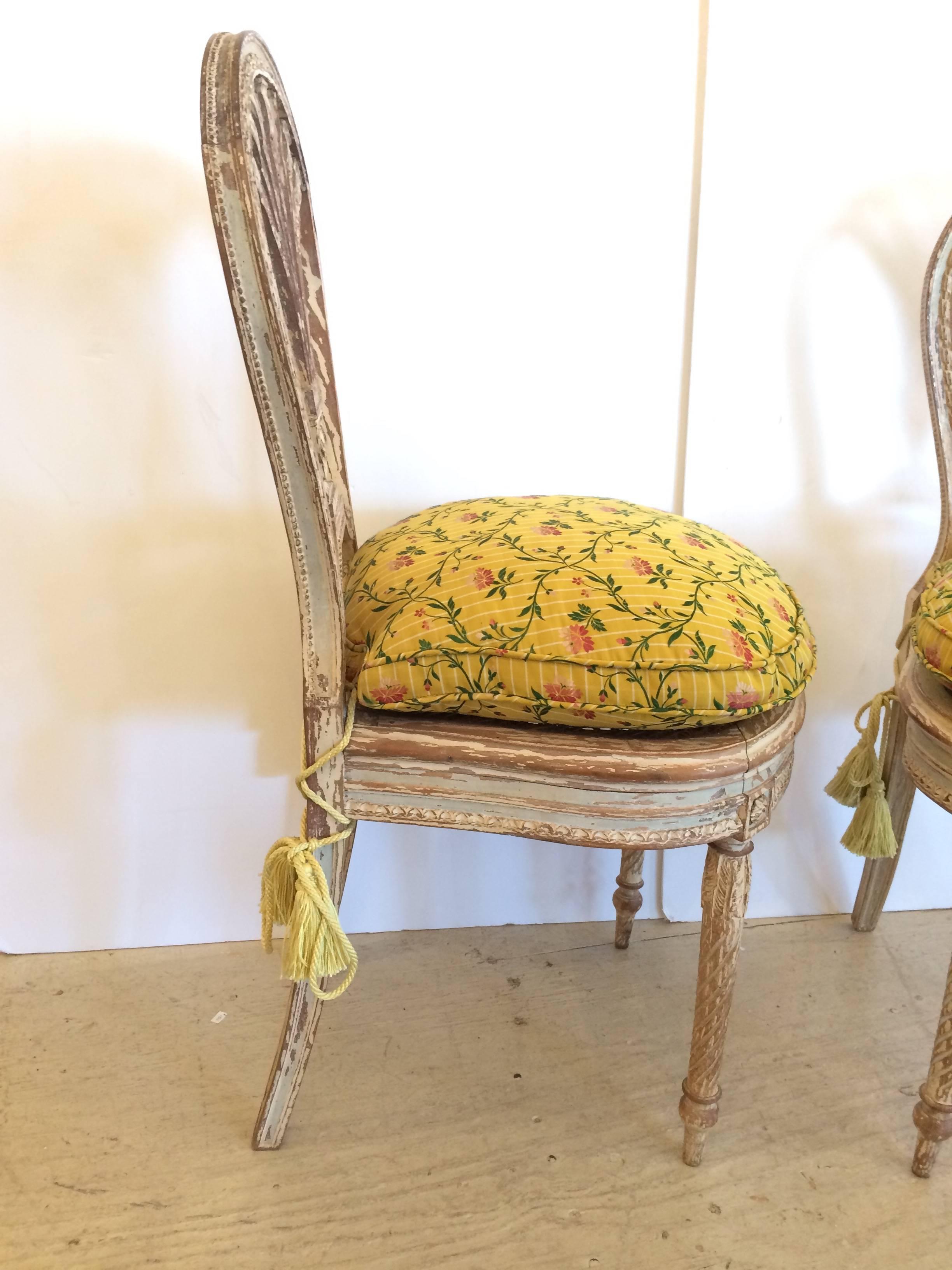 Two wonderful little French Louis XVI style distressed painted side chairs having superb arched backrest with splayed slats, lovely carved tapered legs, caned seats and loose down filled silk upholstered cushions.