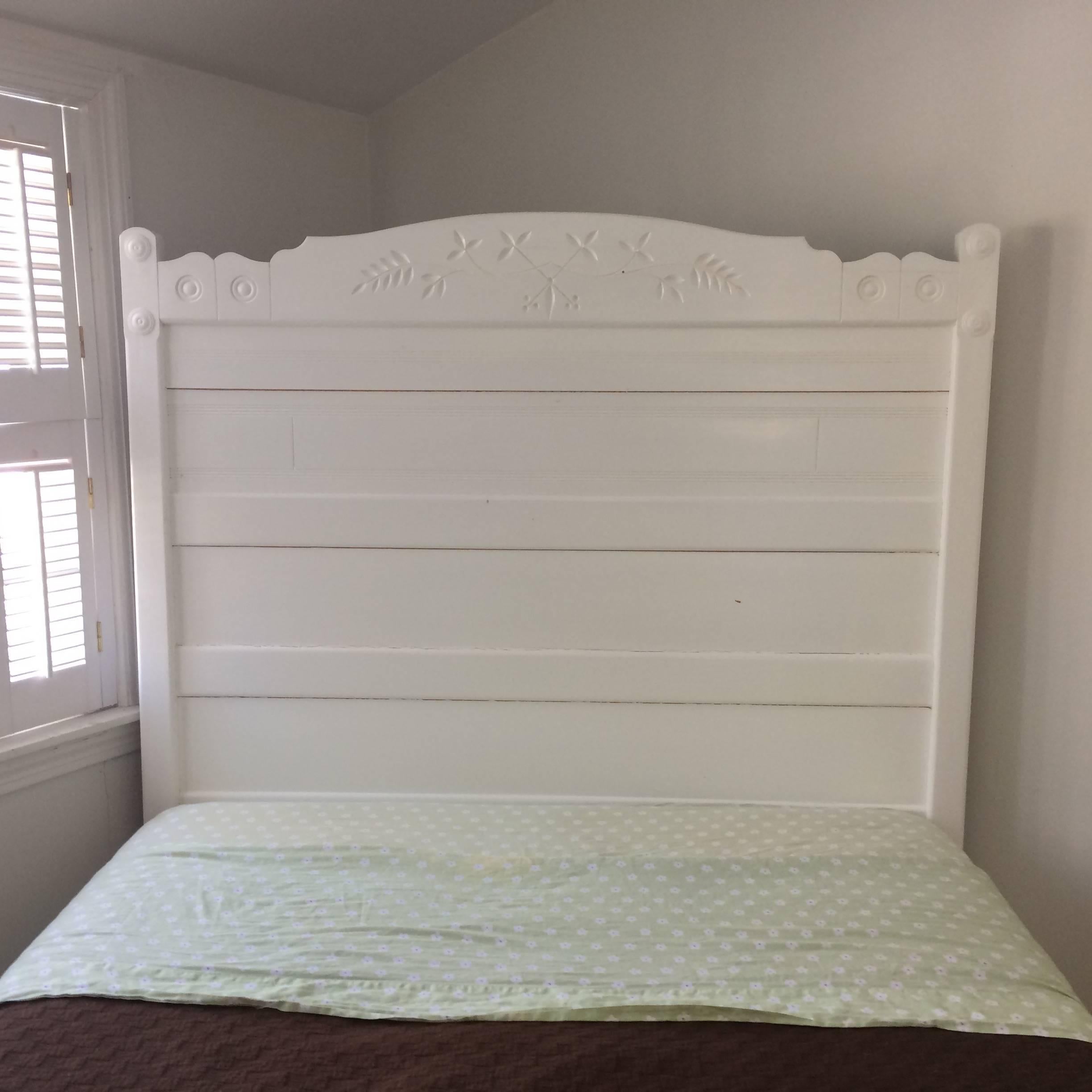 Simple and lovely full sized bed frame, carved wood with circles and leaf motif on the headboard, scalloped side rails, painted a fresh white. Perfect for the guest bedroom in a country house. Full size mattress not included.