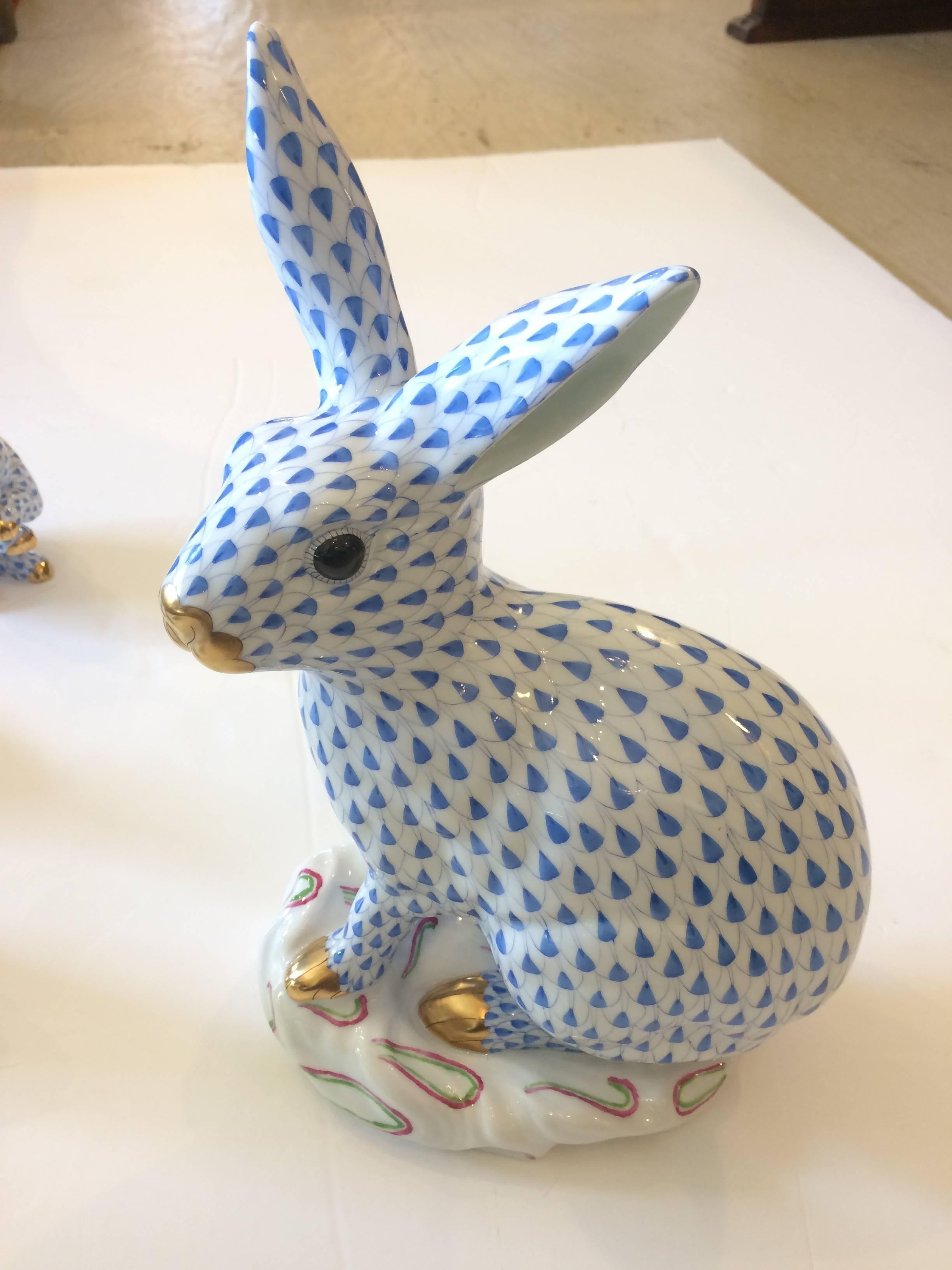 Beloved collection of hand painted porcelain bunnies by Herend. Blue and white with gold embellishments and the Herend stamp on the bottoms.
Range from largest (see measurements below), to medium 4.5 W, 6.5 H, 2.5 D to tiny 2.5 W, 1.5 H, 1.25 D.