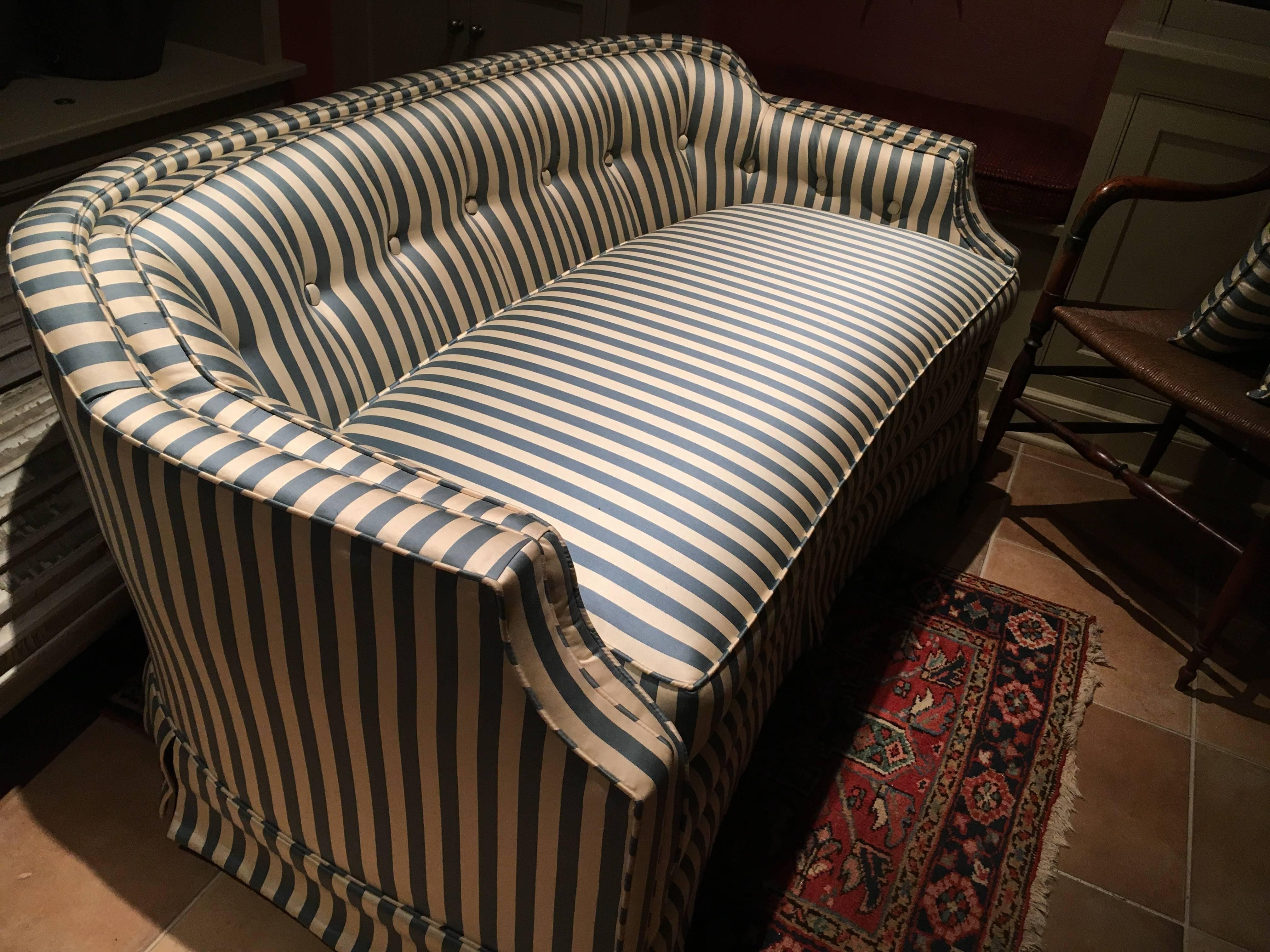 Sophisticated pair of curved loveseats with tufted tight backs and one removable cushion; inverted box pleat corners. Custom upholstery in a slate blue and cream stripe in silk blend fabric. Seat height is 20