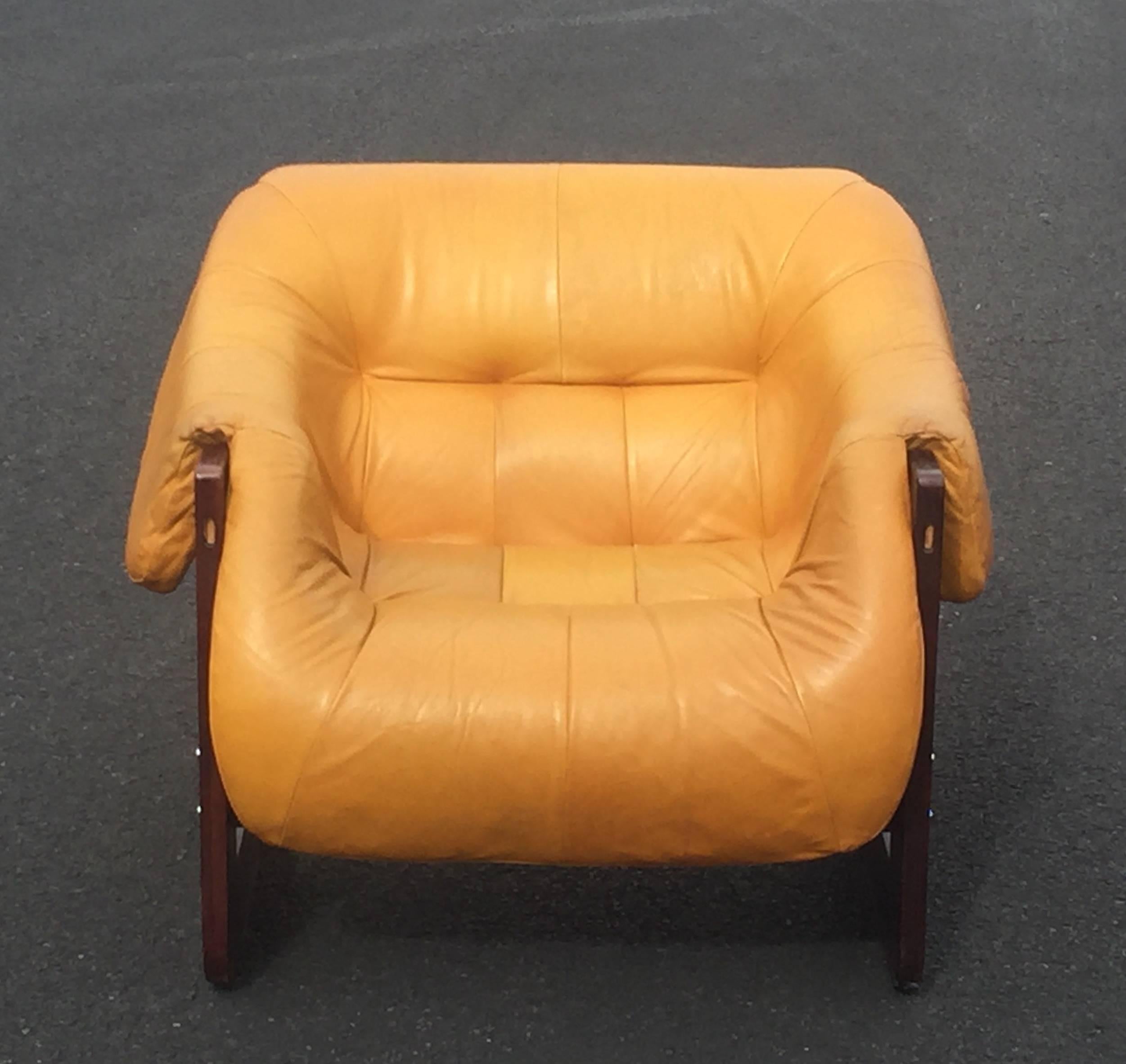 Puffed up iconic leather lounge chair in rosewood and leather by Percival Lafer.
The leather is a beautiful butterscotchy yellow color, with a bit of wear, but more patina than a problem. One small mark or line as shown in photo. No rips or