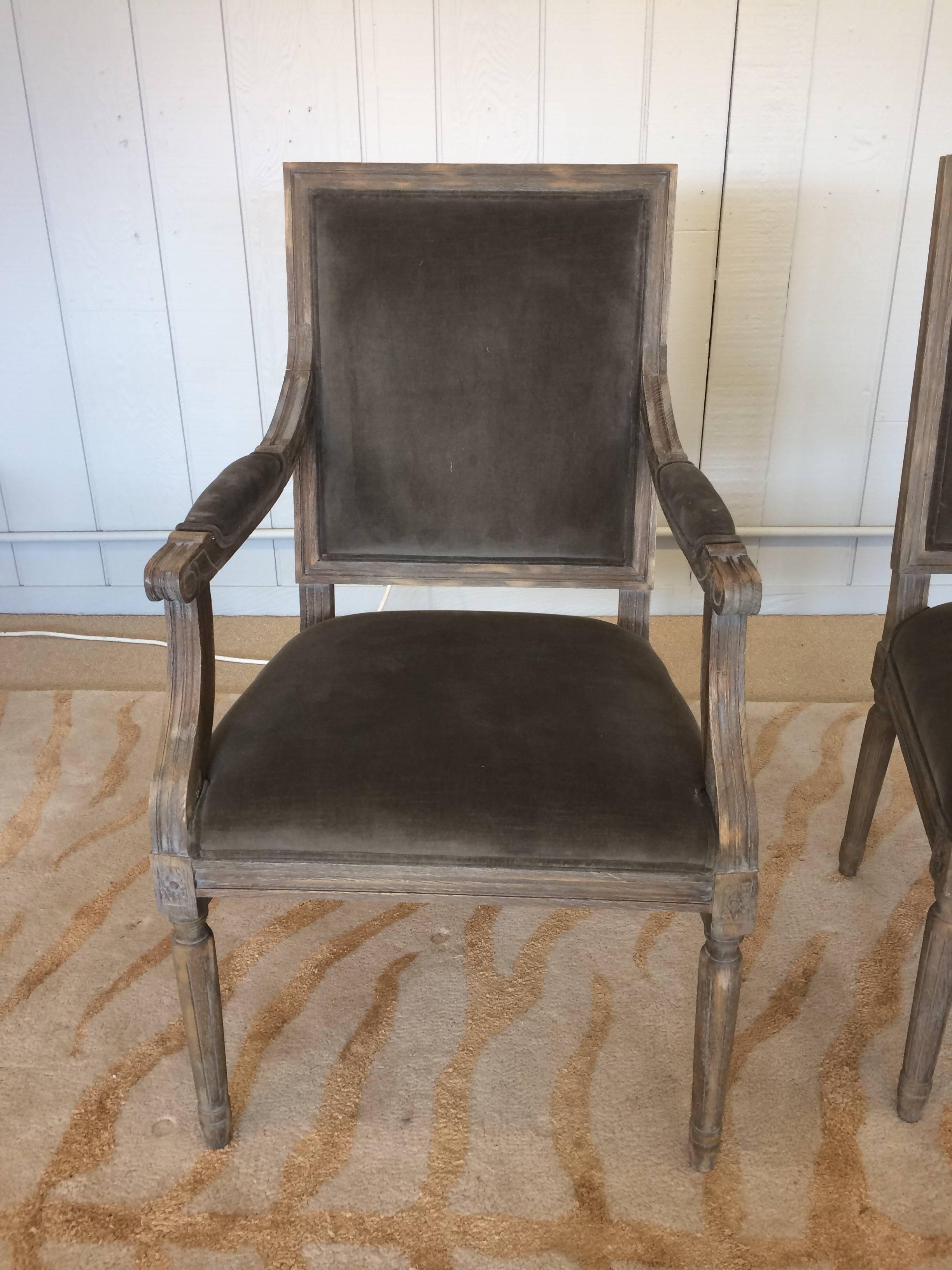 Stately set of six French style Dining chairs by Restoration Hardware. White washed oak in taupe cotton velvet. Pretty carving on legs. Two armchairs, four side chairs. Each measures 18