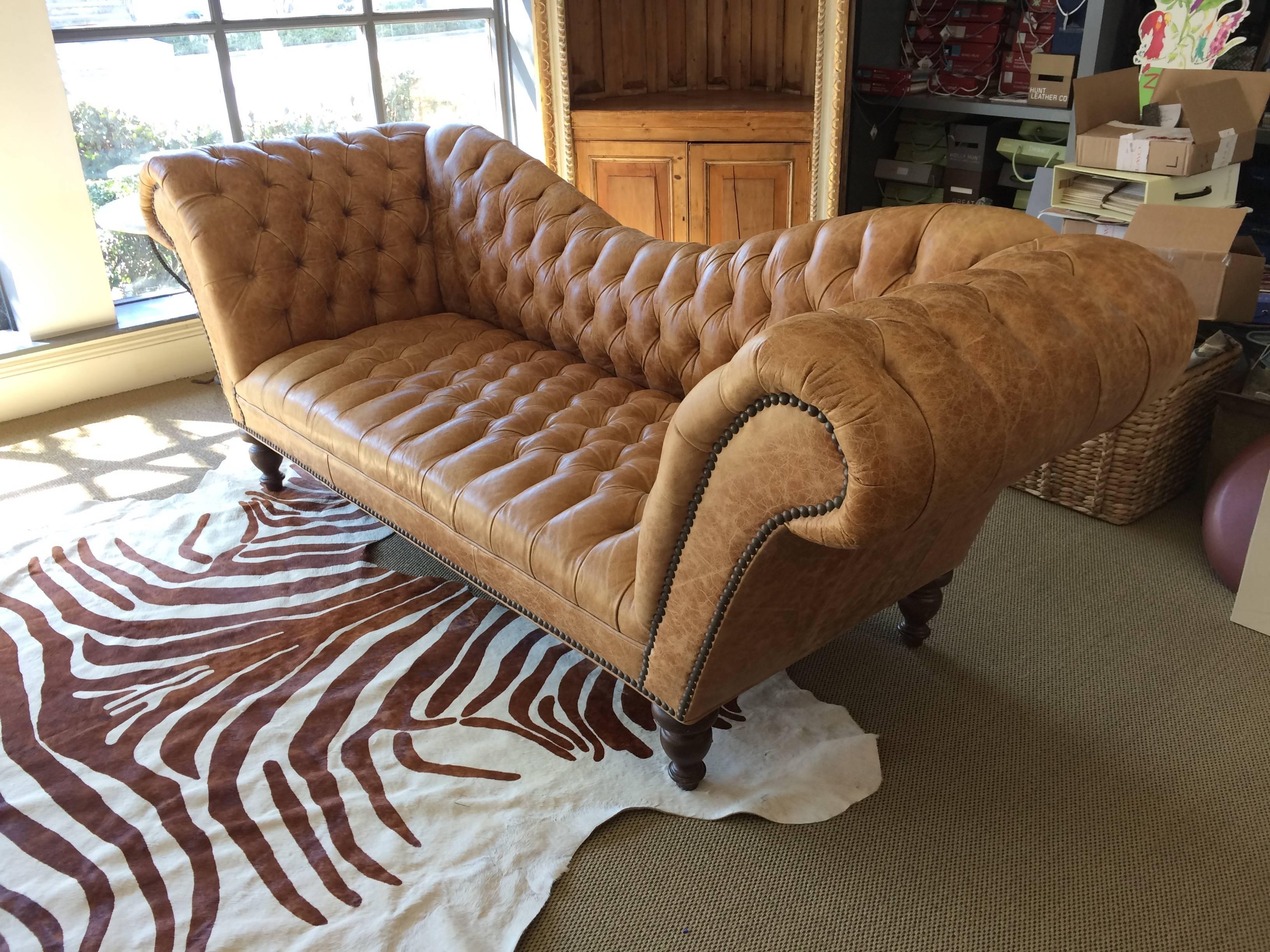 Absolutely delectable distressed caramel leather tufted Chesterfield with sumptuous curvy back and arms that spay outward. Gorgeous from every angle. Mahogany turned feet on brass casters. Very comfortable and large seat. Measures: 24