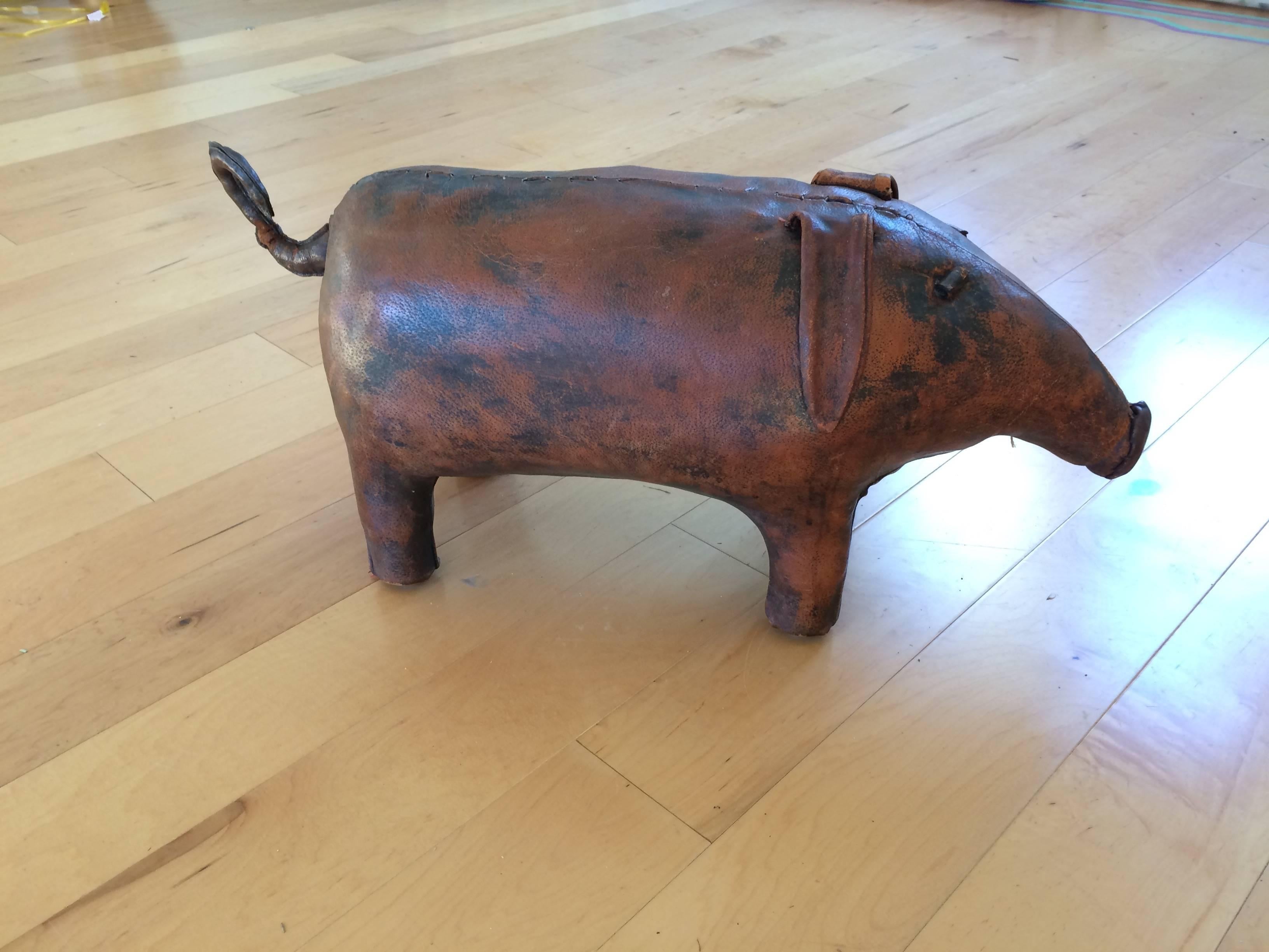 Irresistible distressed leather vintage pig ottoman by the famous Abercrombie & Fitch Co. Wonderful aged patina to the leather.