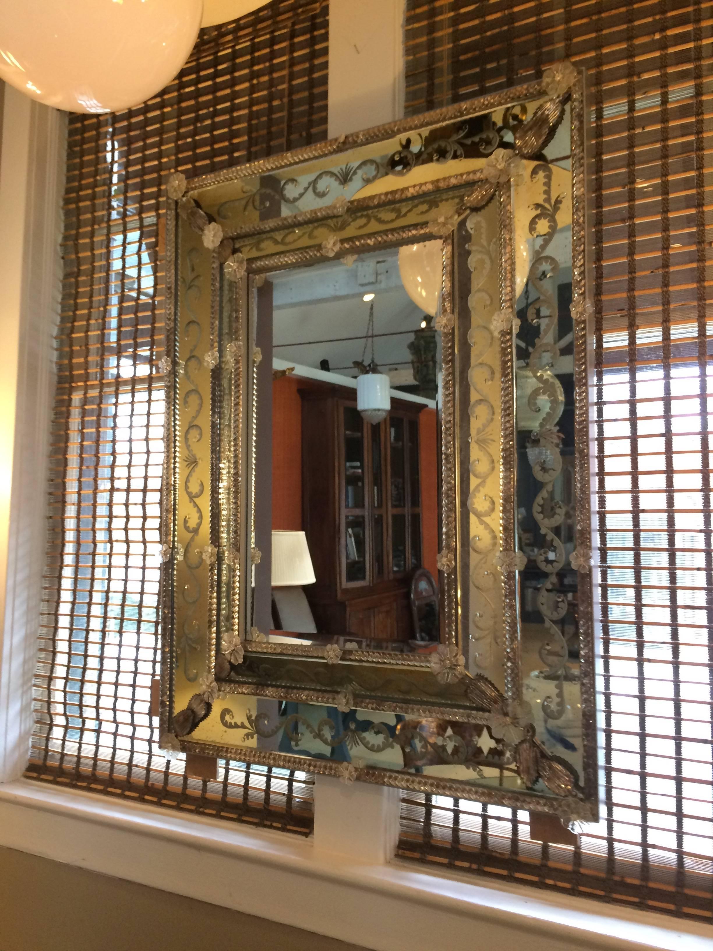 Show stopper rectangular Venetian mirror with ornate etching and cut-glass adornments. Interior mirror is  16 1/2 inches wide by 27 1/2 inches tall