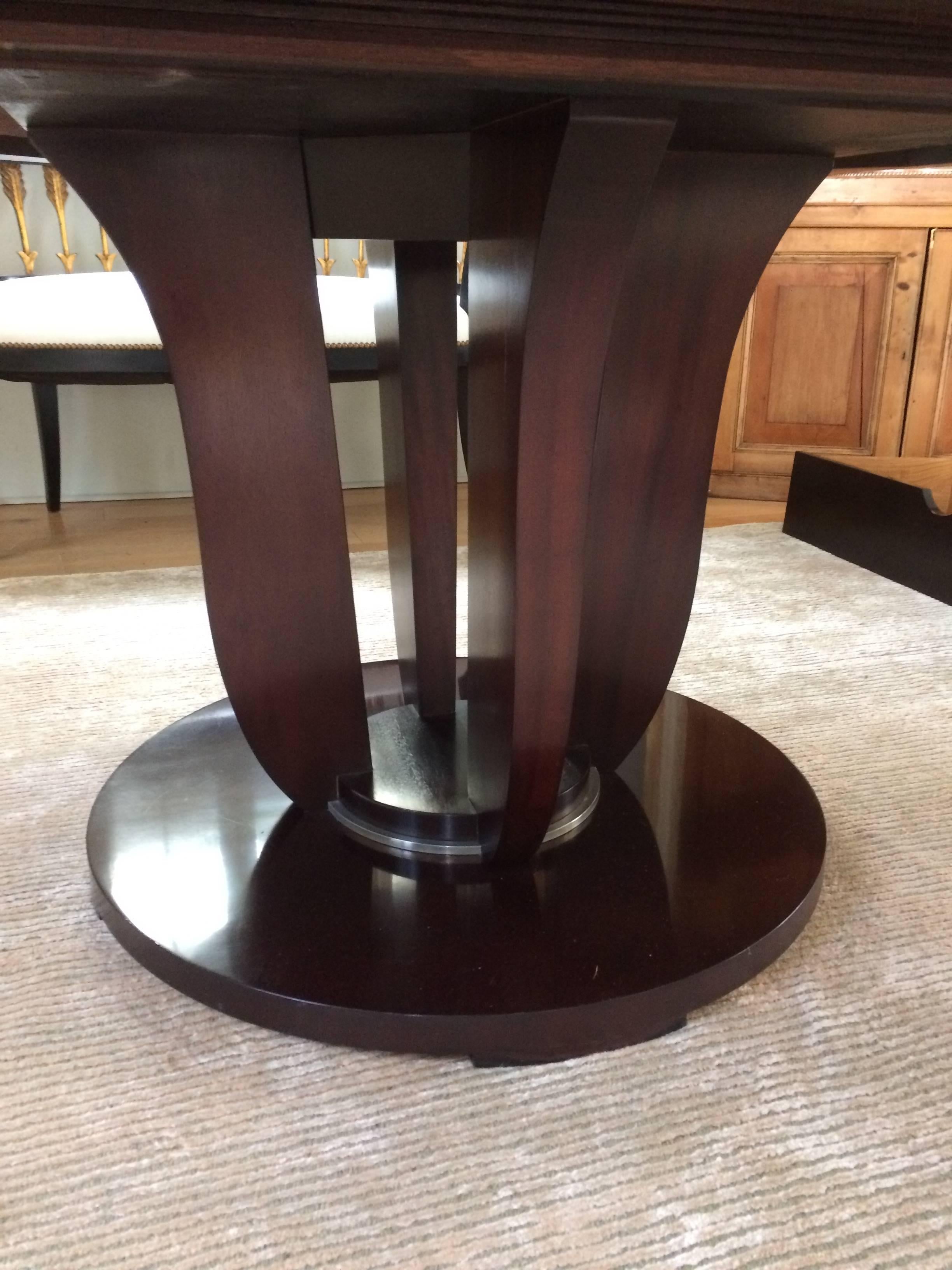 Handcrafted mahogany in Java finish, a chic round dining table with lovely leaf motife pedestal. Has a glass top available, which was used to protect the table by former owner.

Note: Matching sideboard and eight chairs available.