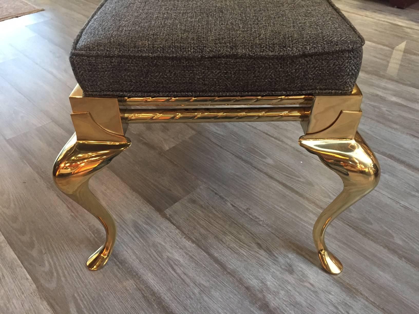 Glamorous rectangular bench having a solid brass base with stylish cabriole legs, newly upholstered in a refined grey menswear fabric.