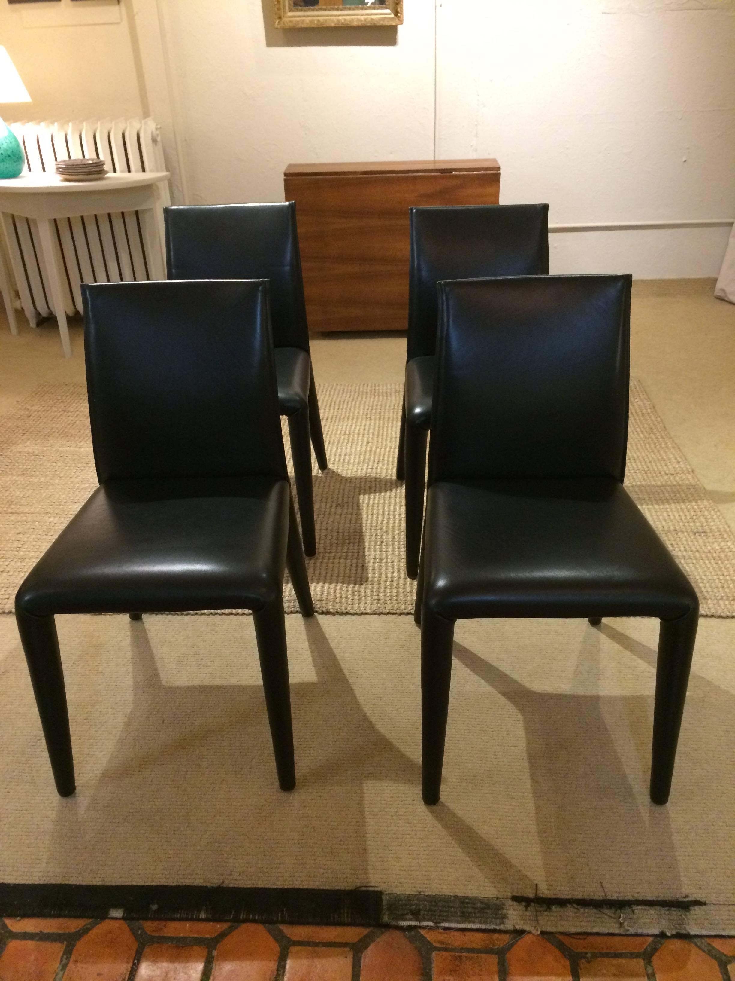 Beautifully made seamless supple black leather side chairs by B & B Italia. Mint condition. Designed by Mario Bellini.