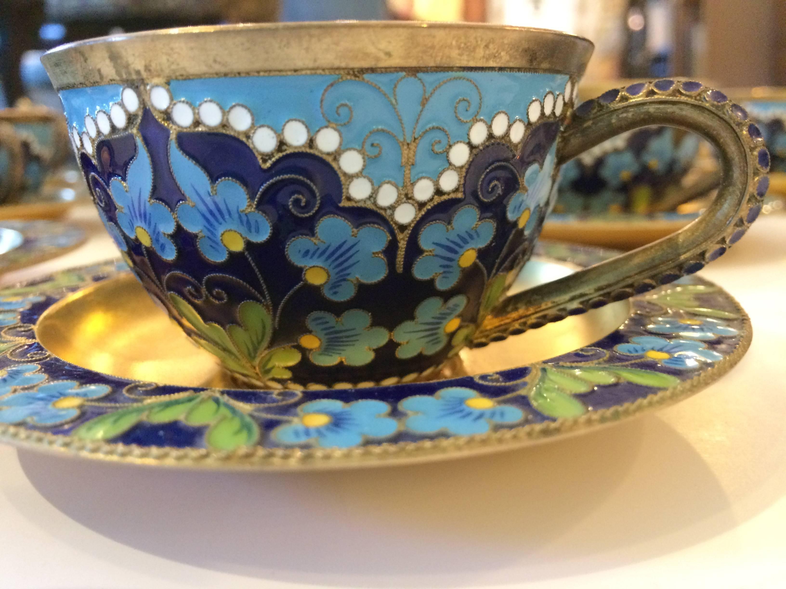 Fifty piece Russian cloisonné enameled sterling silver tea set plated in gold.
12 teacups, 12 saucers, 12 teaspoons, 12 tea strainer holders, a tea strainer and a round sugar bowl with a swing handle.
Each decorated with cobalt, turquoise, green,