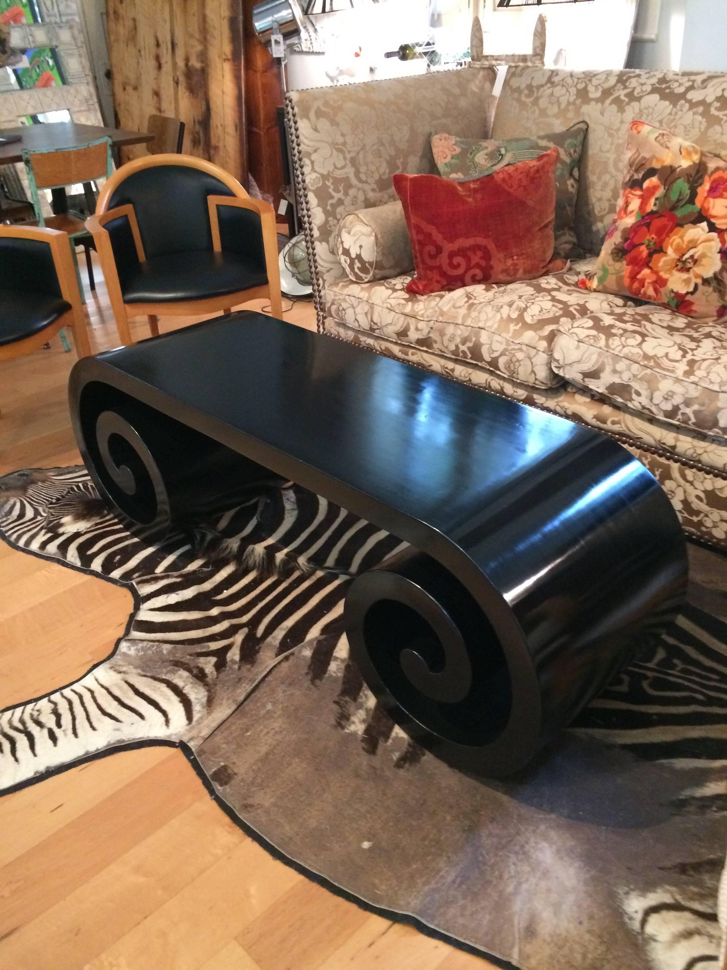 Wonderfully shaped Mid-Century Modern sleek yet chunky coffee table with scroll base, newly refinished in a satin black.