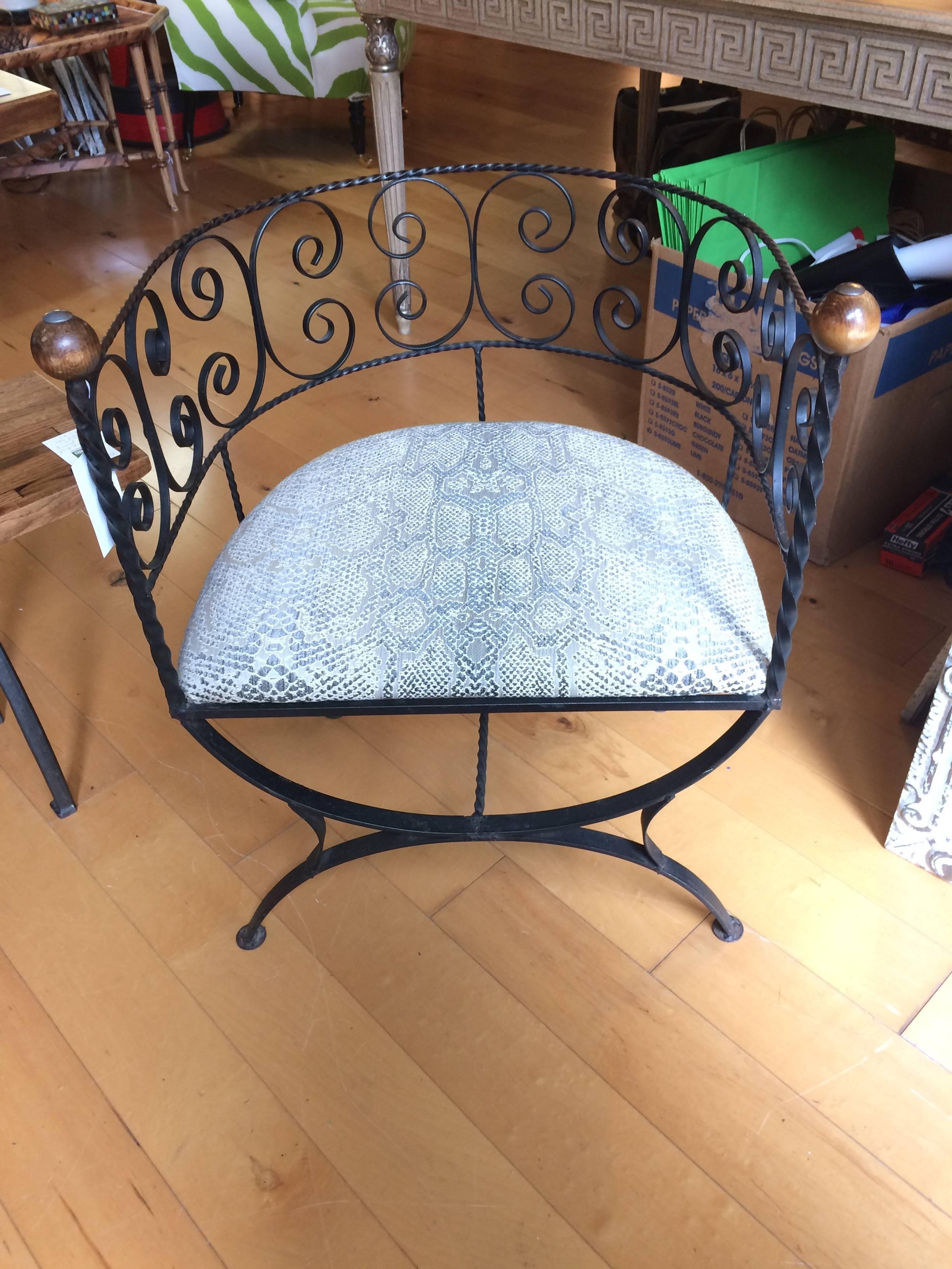 Lovely and unusual pair of barrel shaped chairs having airy wrought iron frame and wooden ball finials on the ends. Cushion is Cowtan & Tout faux snakeskin pattern.