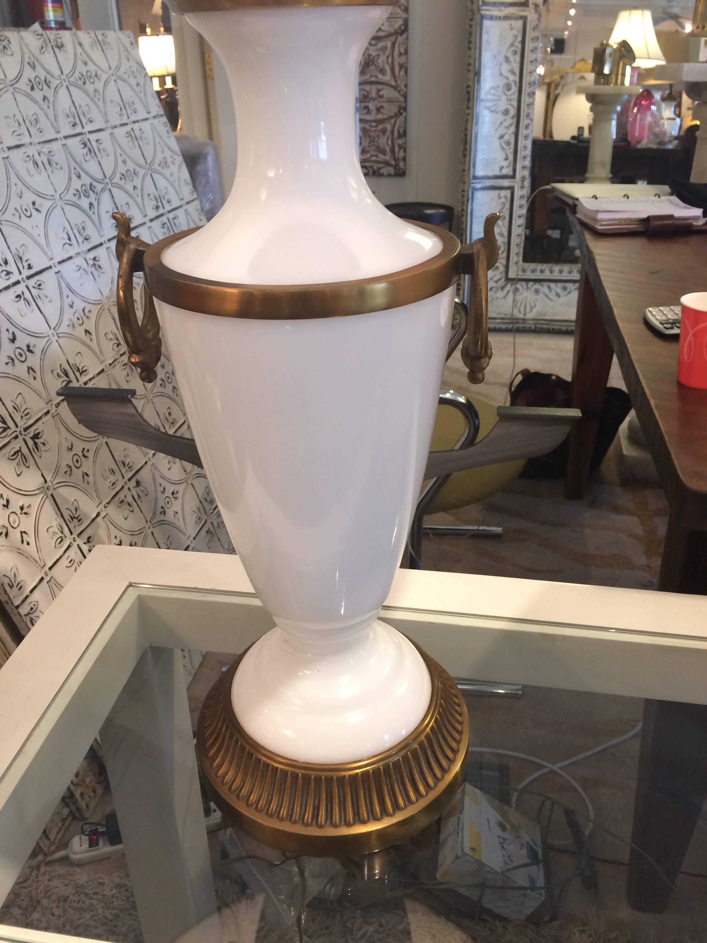 Two very elegant large table lamps in creamy opaline adorned with decorative brass, including handsome rings off the sides. Lamp base is 22.5 H.
Base 8.5 diameter.