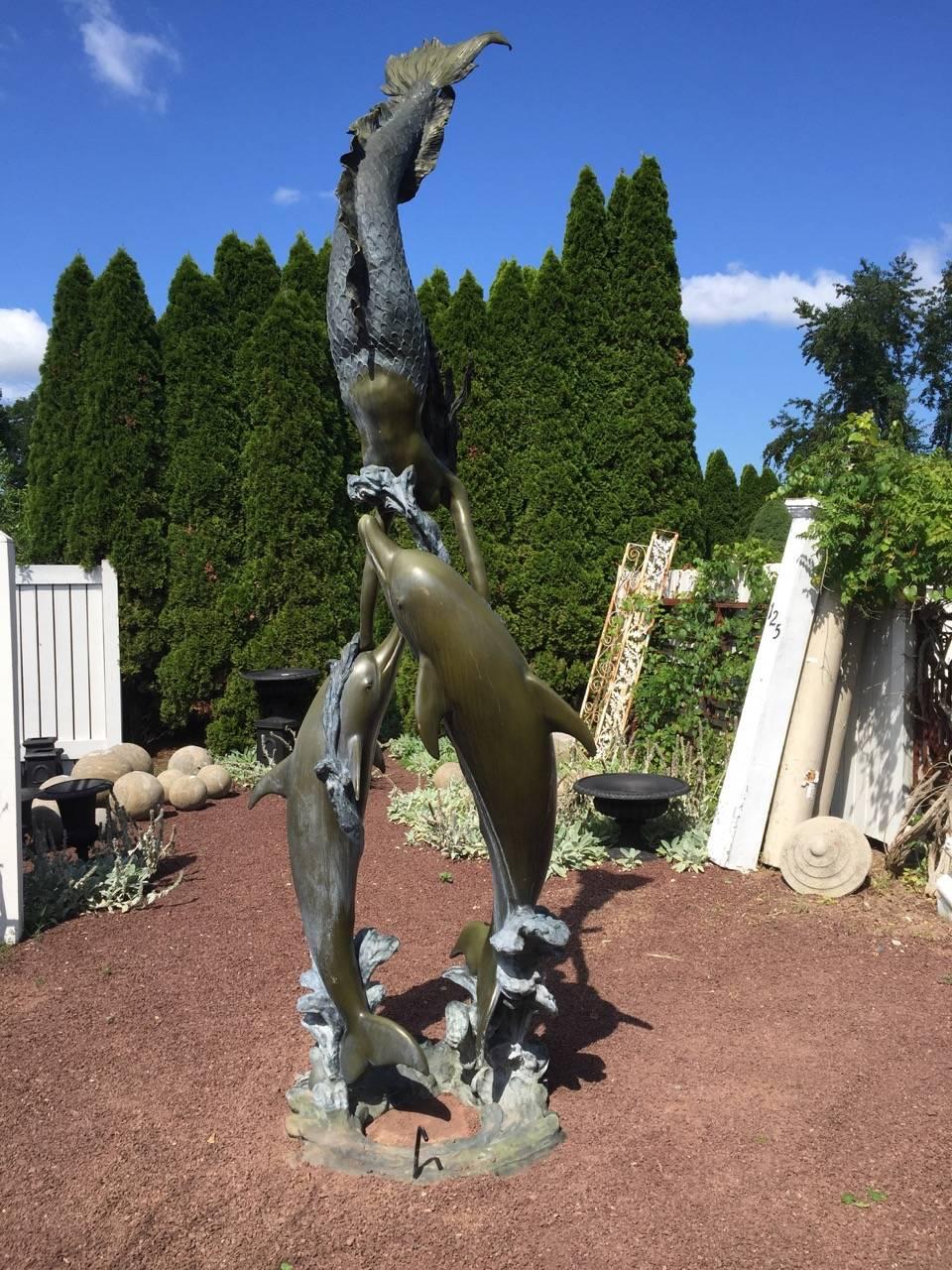 Monumental bronze statue with mermaid and dolphins. Signed “Jim Davidson” and approximately 30-40 years old. 12 ft 6 inches high and weighs approximately 600 lbs.
 