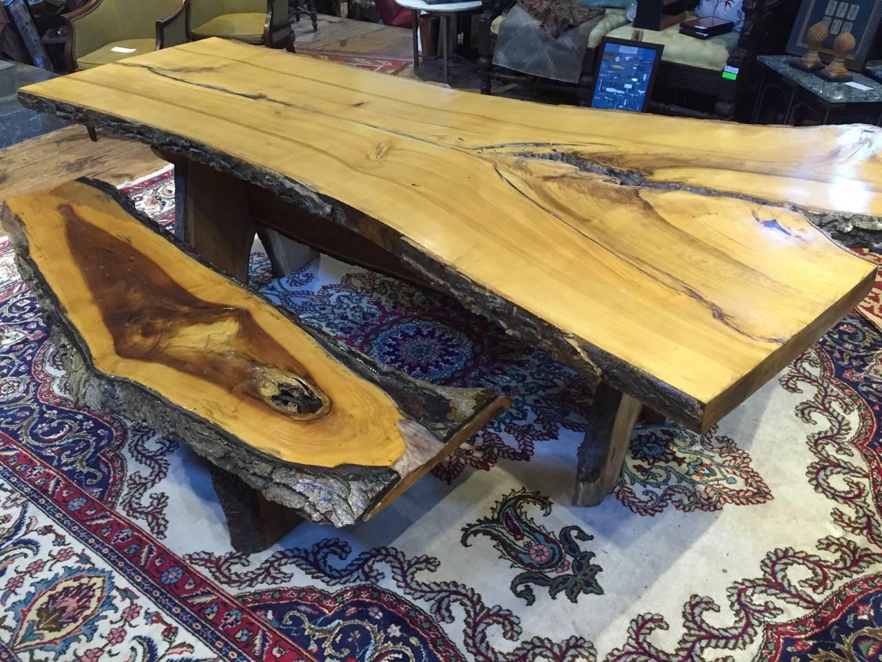 Pine live edge dining table with two benches. Table measures 33” wide at narrow end, 53” wide at wide end, 8 ft 6 inches long, 30.5 high and 2 7/8 thick. 

Benches measure: 76” long, 18” high and vary from 14-18” deep.

Polyurethane finish on