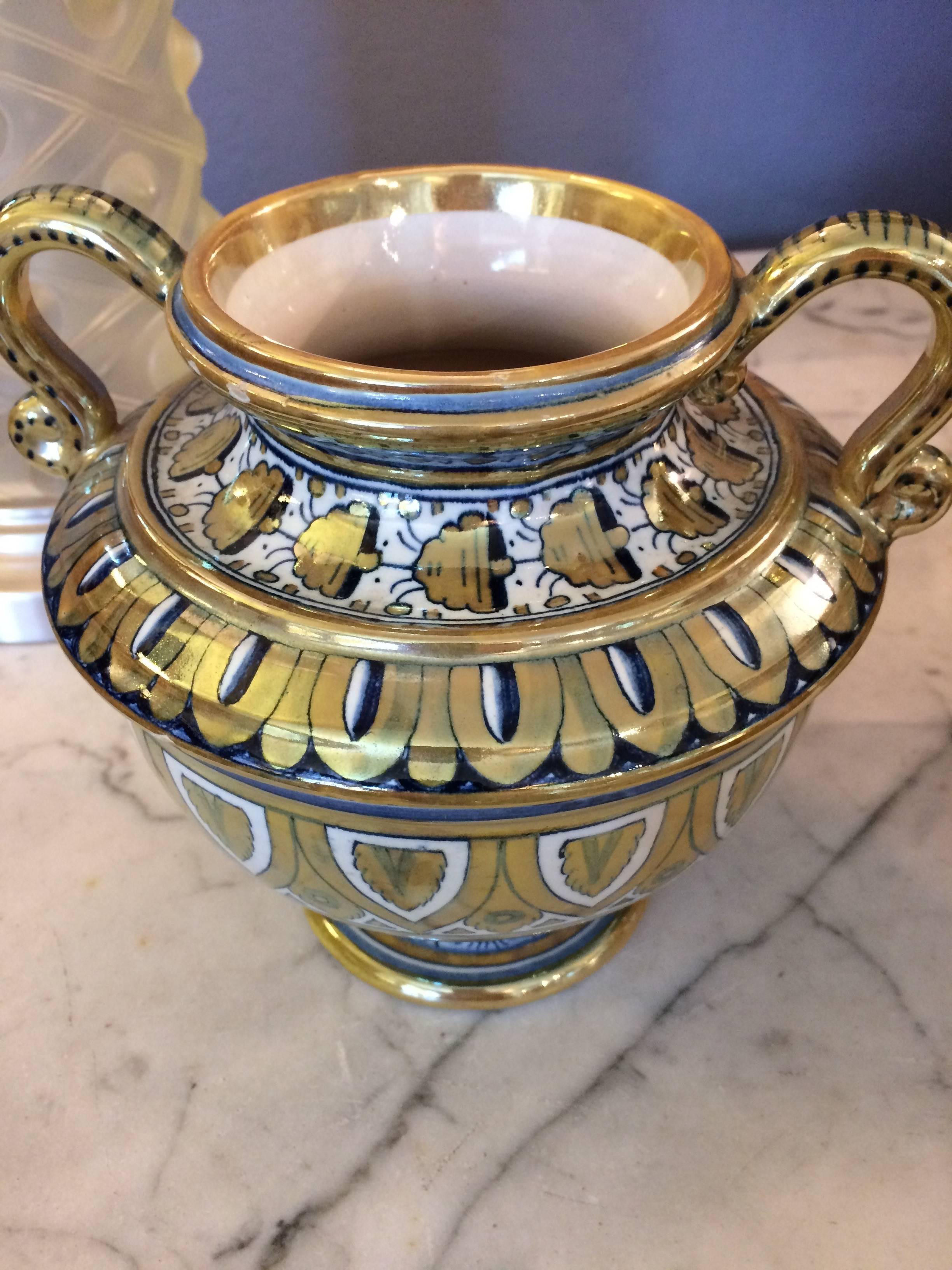 Lovely pair of compotes with urn shape and curved handles, having gorgeous white, gold and navy blue intricate pattern.

 