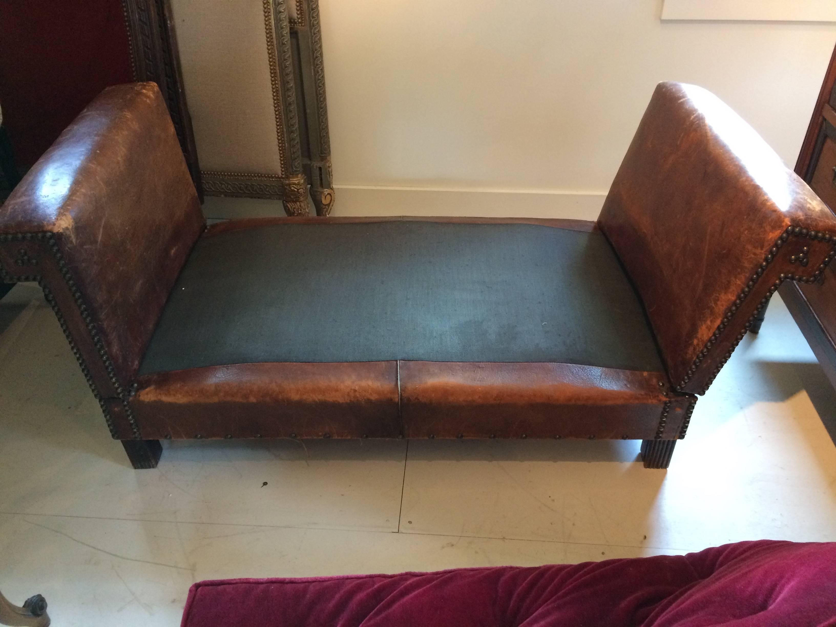 Absolutely wonderful distressed leather daybed and loveseat, having buttery brown leather finished with brass nailheads, and a down filled maroon upholstered mattress/cushion. 
 Sides flatten to extend the sleeping surface to 79 L when fully open. 
