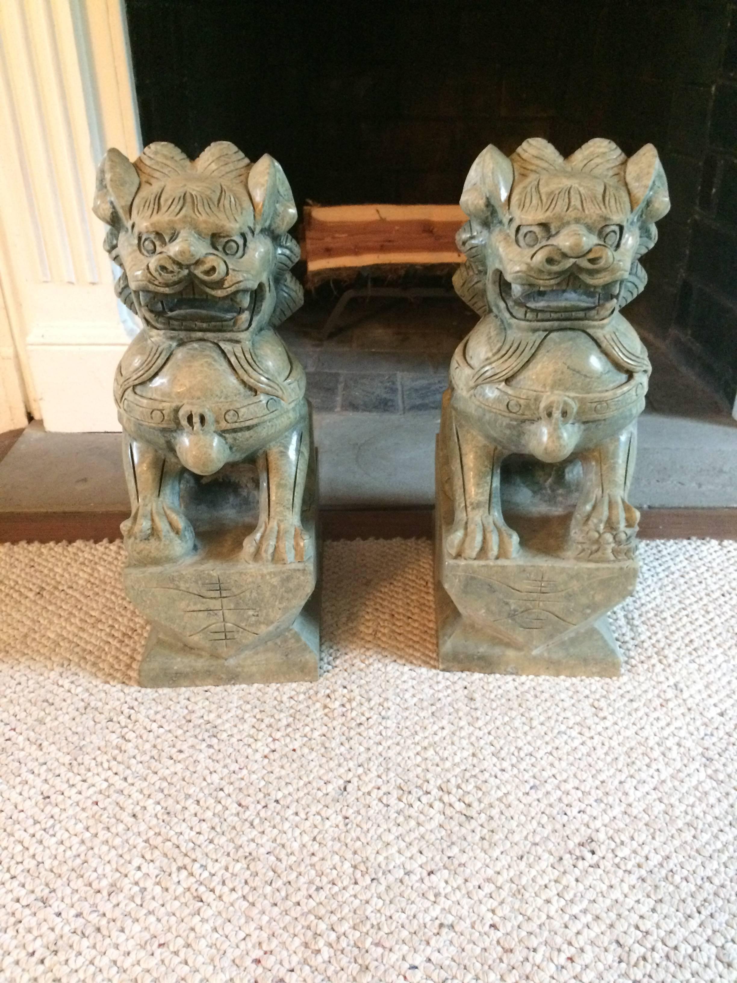 Impressively large and heavy carved hard stone foo dog sculptures. Lovely shade of soft green.