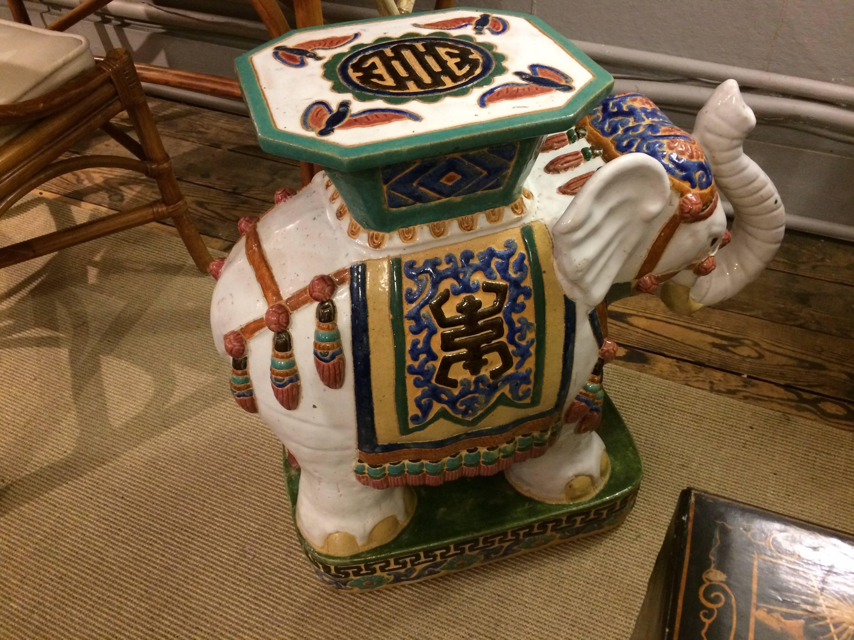 Wonderful hand-painted ceramic garden stool in the shape of an elephant with his trunk in the lucky upright position.