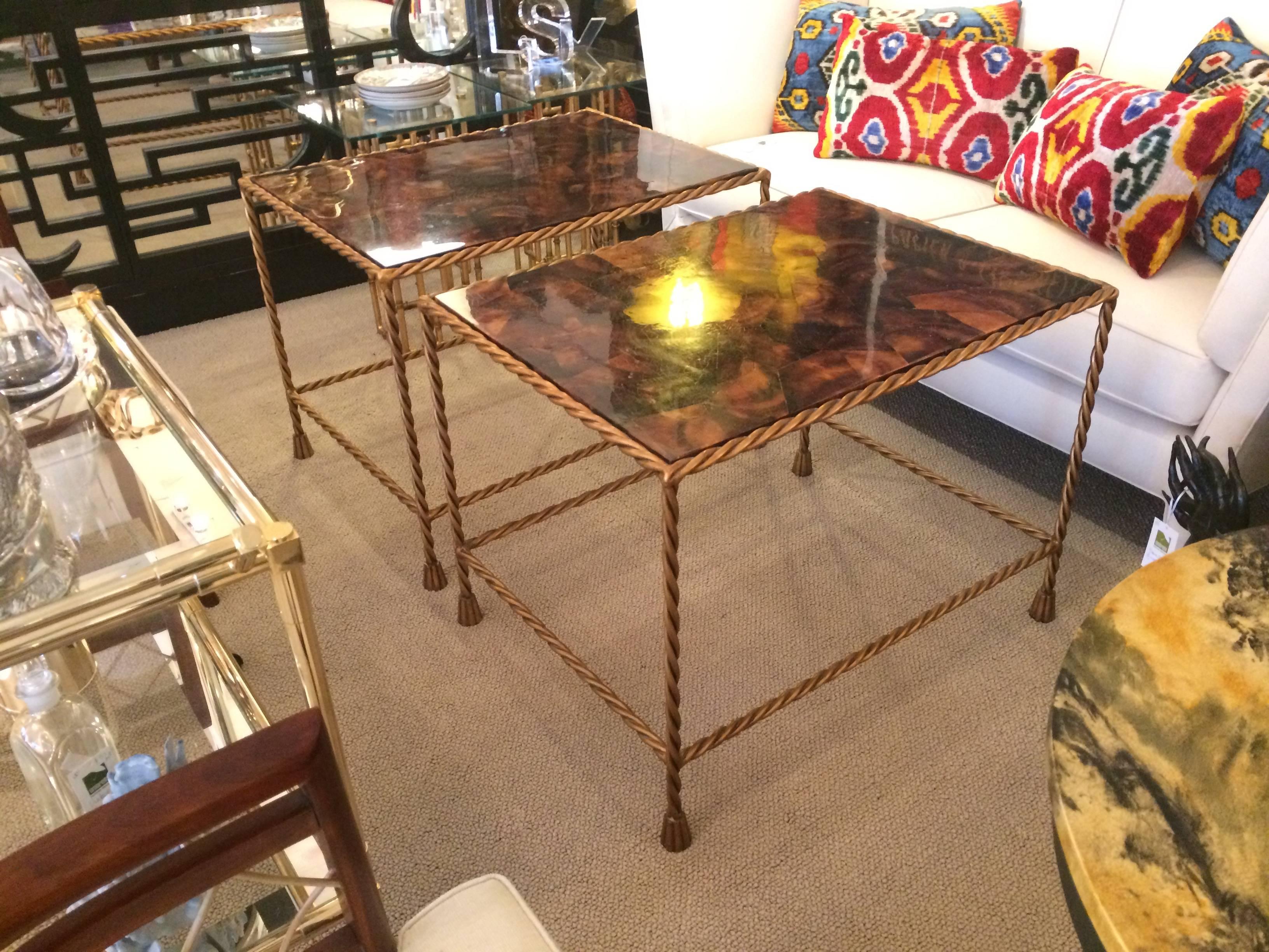 Timeless and sophisticated pair of Italian end tables in gilt and faux tortoise shell. Frame is twisted gilt metal terminating in tasseled feet. Tops are a tortoise shell veneer over wood.