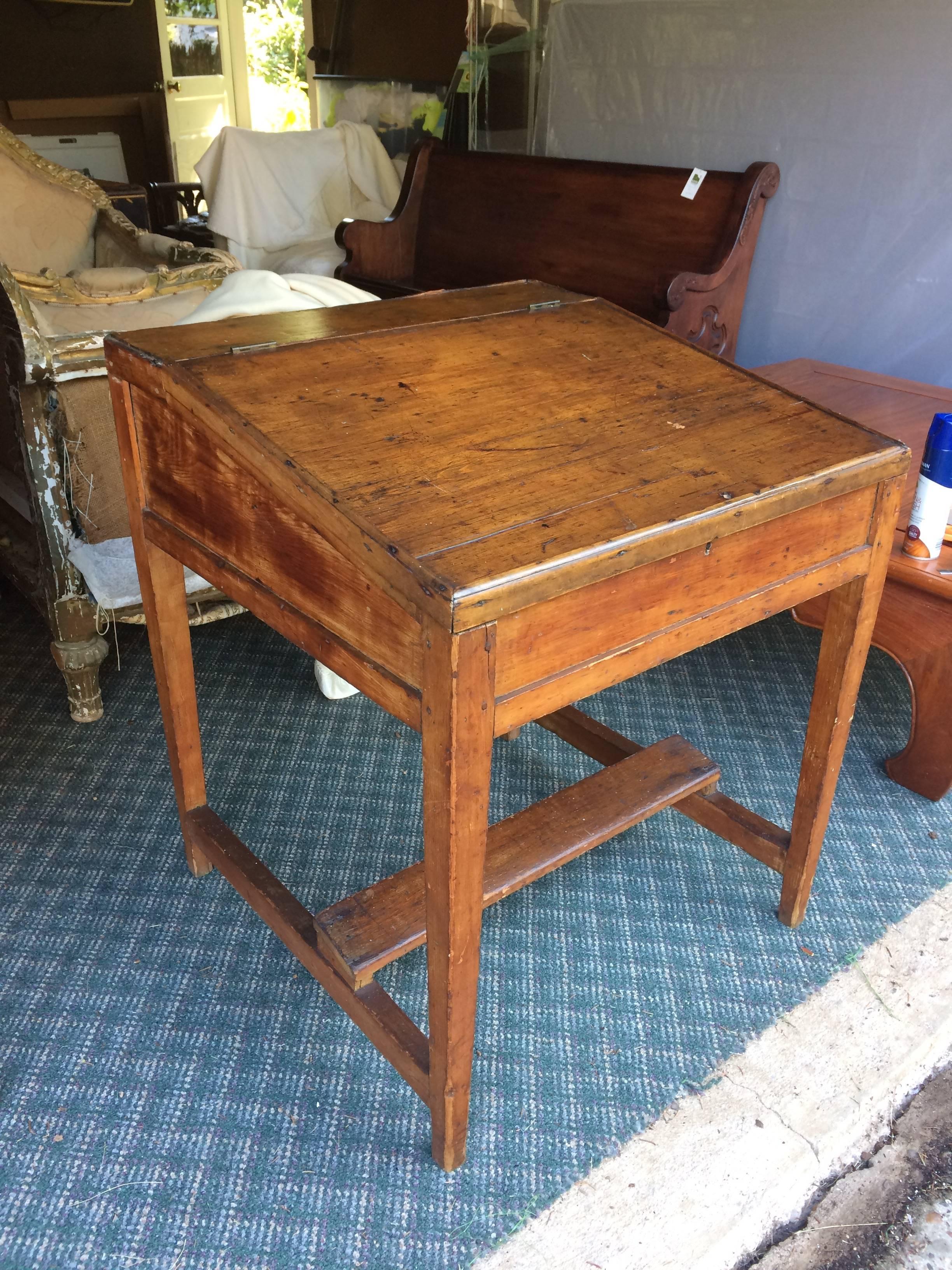 Vintage slant front desk with wonderful character, a plank underneath as a foot rest and a surprise salmon colored interior.