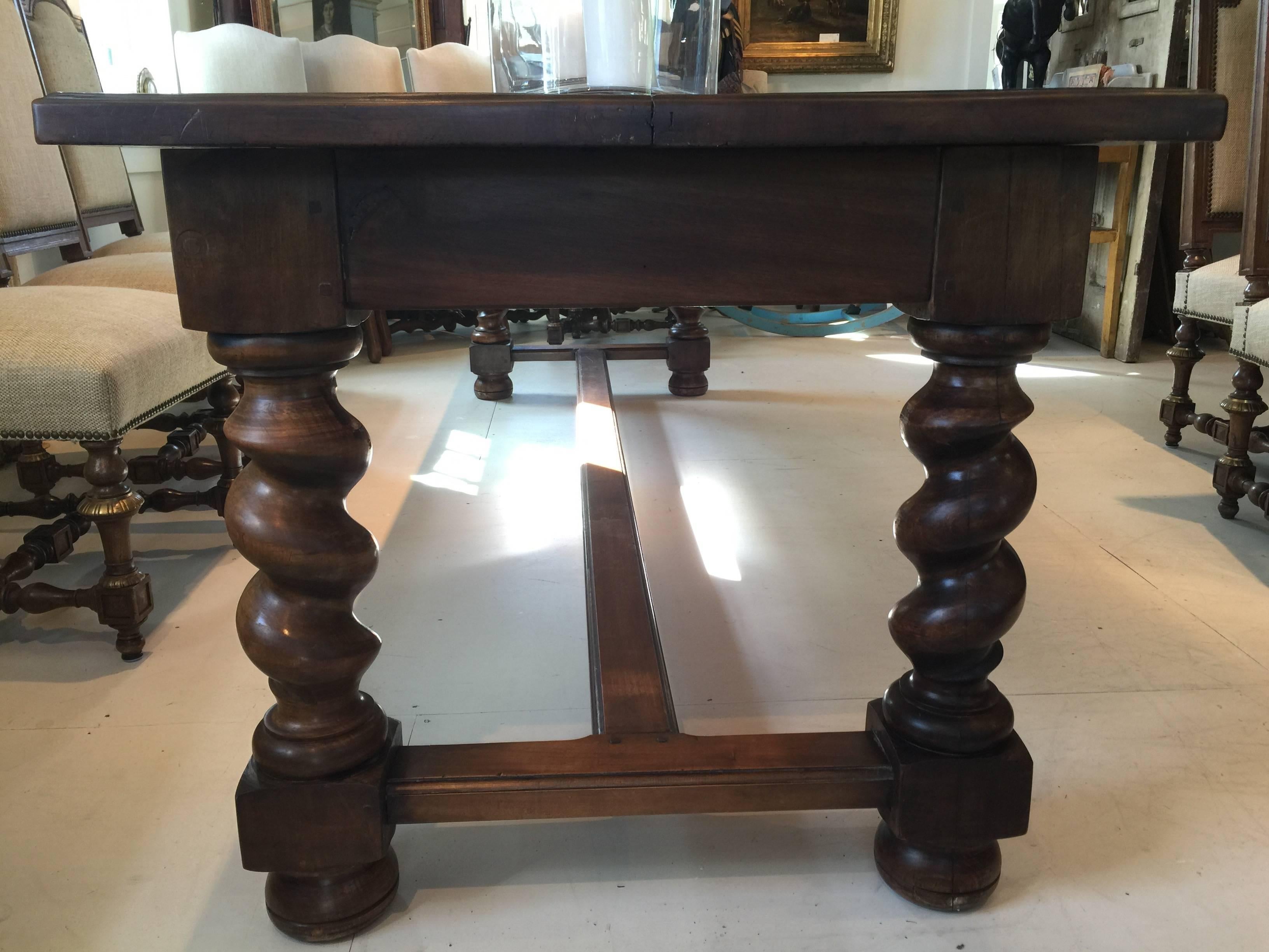 Walnut French refectory table, bought in Avignon, France, having three working drawers on the side and a top in two pieces with seam down the middle. Barley twist style chunky legs, beautiful patina and in great shape. 
 
Dimensions:
8’8 ½