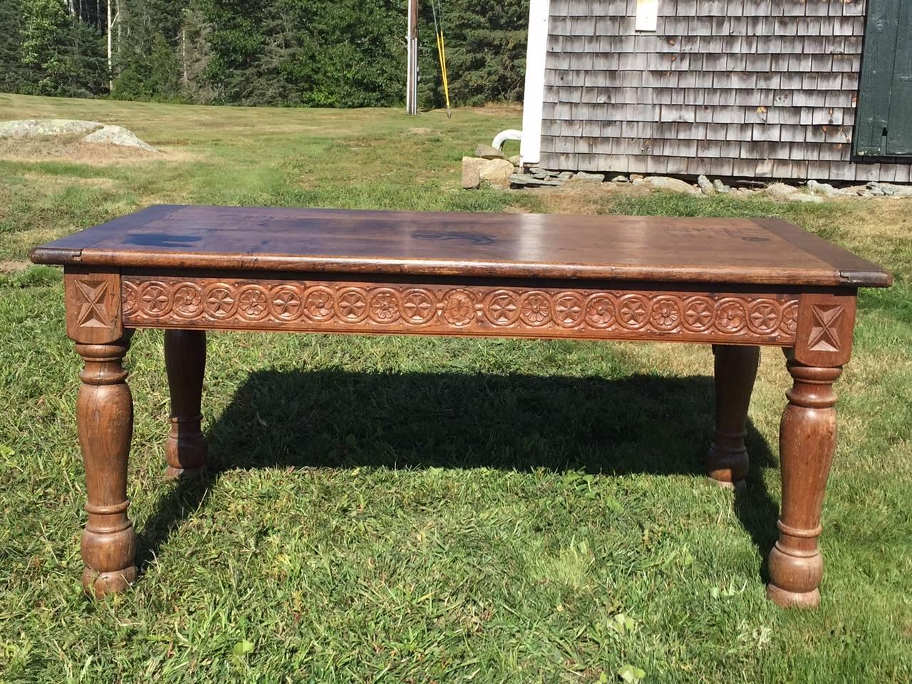 100 year old, charming French oak country table from Provence. Note marks on top, which are not indented-- just ink. Adds to its rustic character. Lovely carving around the apron and on the legs.   The apron height on the French country table is 23