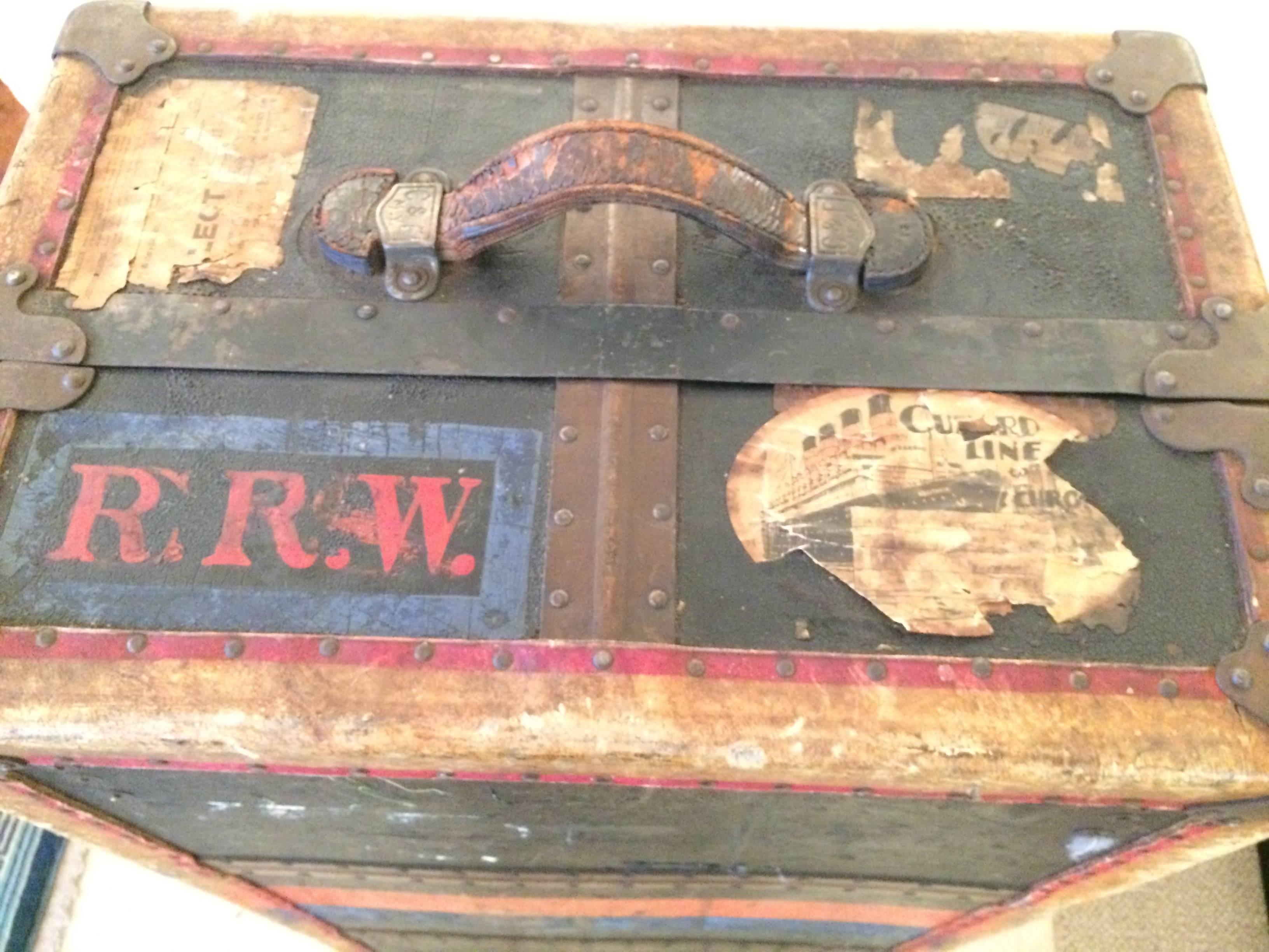 Superb top of the line Crouch & Fitzgerald travel trunk dated 1868 having unbelievable character with red and green stripe, red RRW initials, and weathered labels including one that with a ship that says Cunard Line. Would make a fabulous coffee