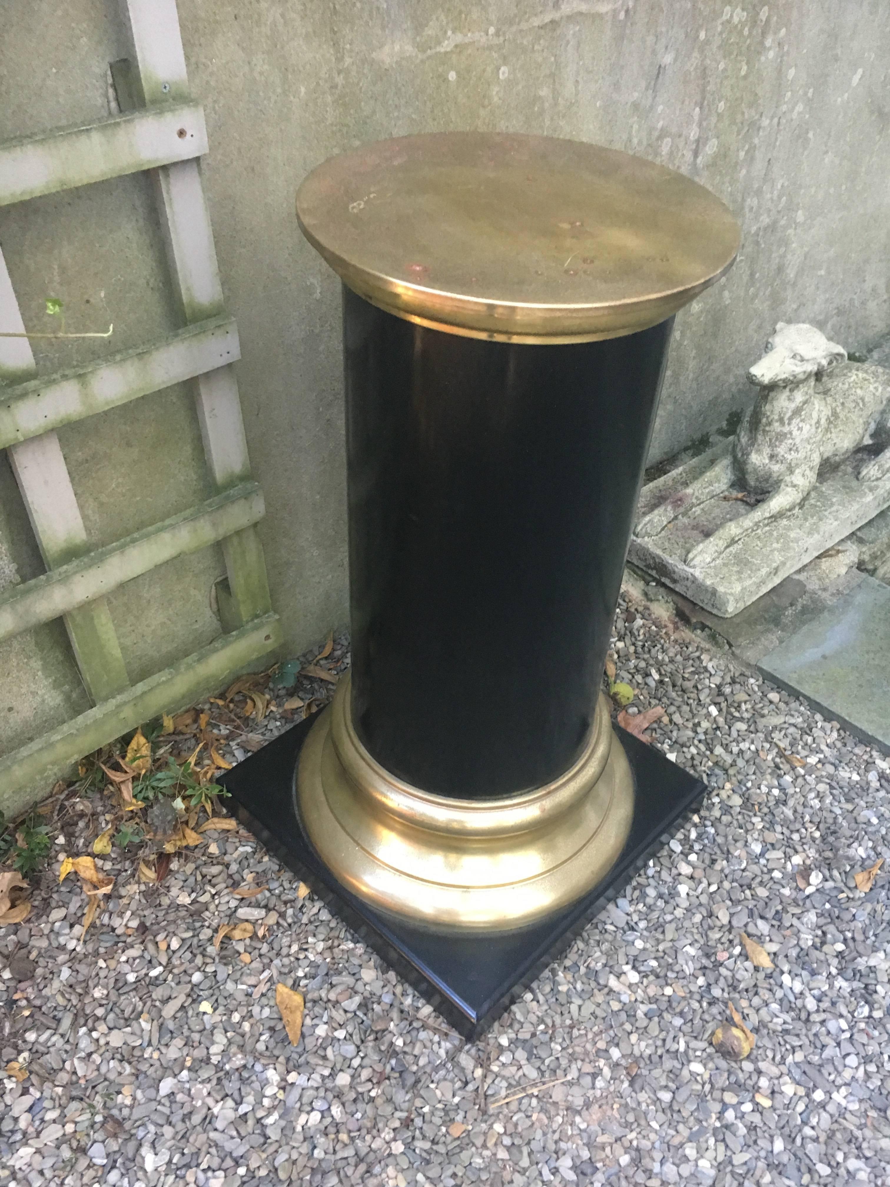 Handsome pair of wood and brass midcentury pedestals. Base is 17 inches square and diameter of brass tops is 13.5. Square base and column is constructed of wood; trim and top is brass. Some dis-colored spots on tops.
   