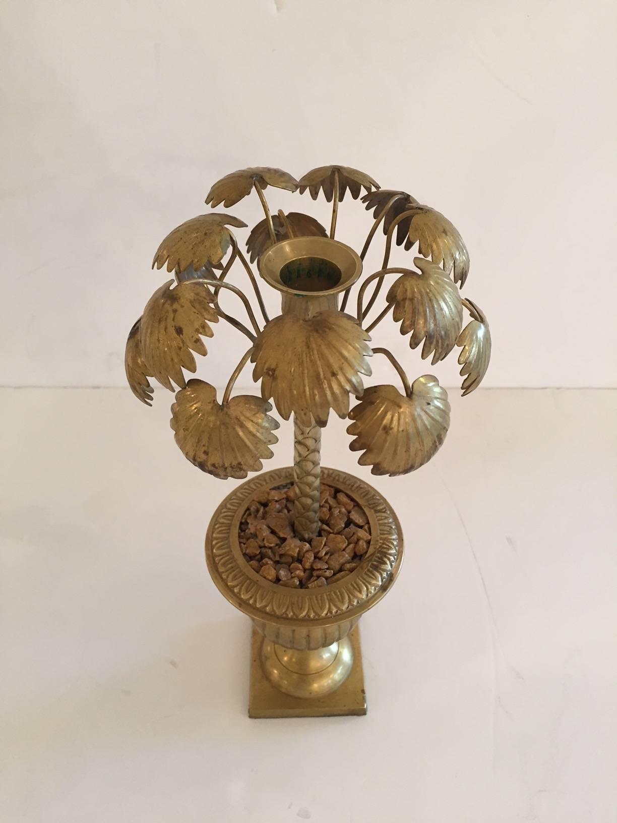 Super stylish and fun set of four brass candlesticks that look like potted palm trees.
   