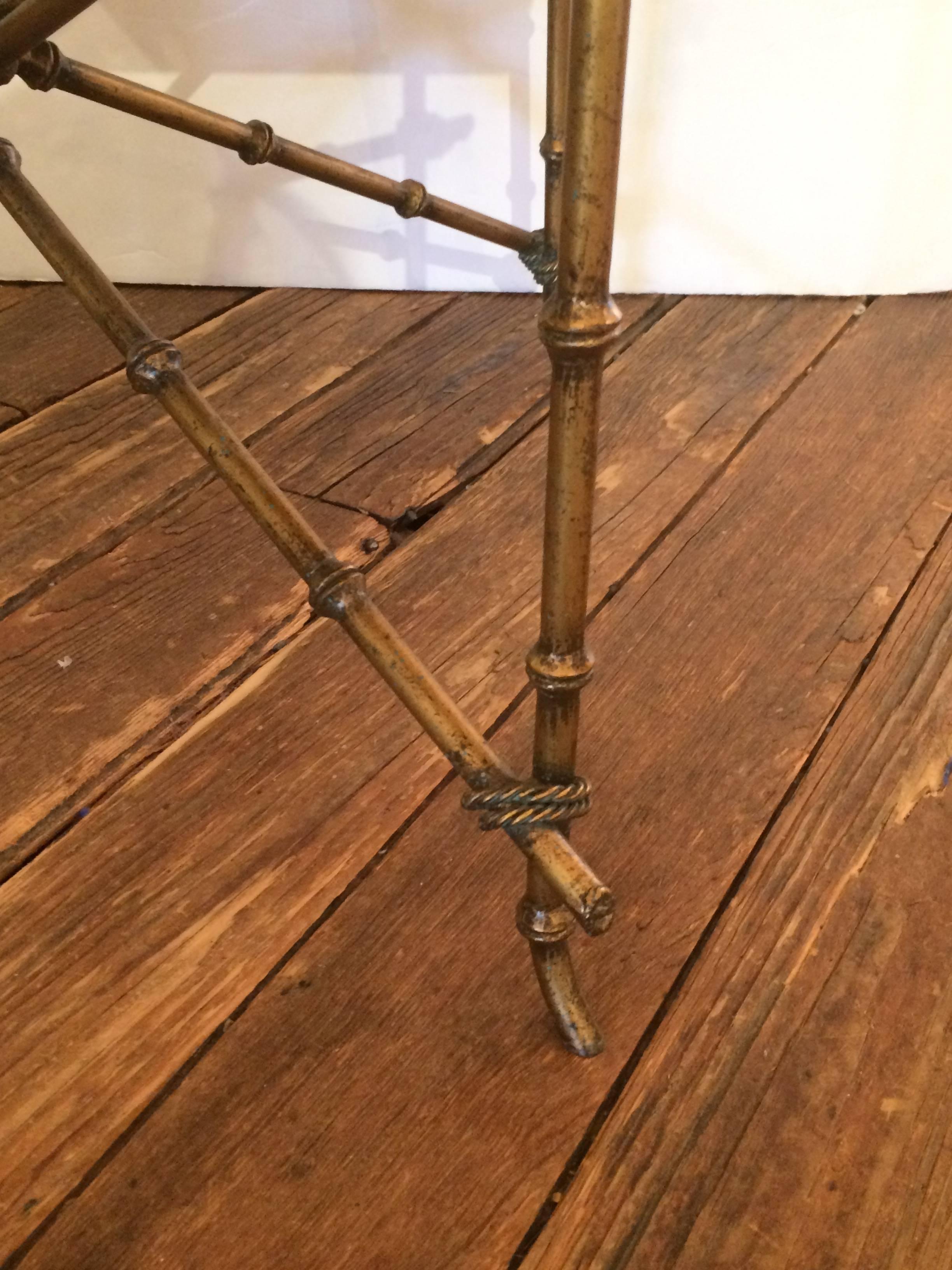 Handsome square end table or small cocktail table having silver leaf mirror top framed in walnut, resting on a stunning gold faux bamboo stretcher style base.