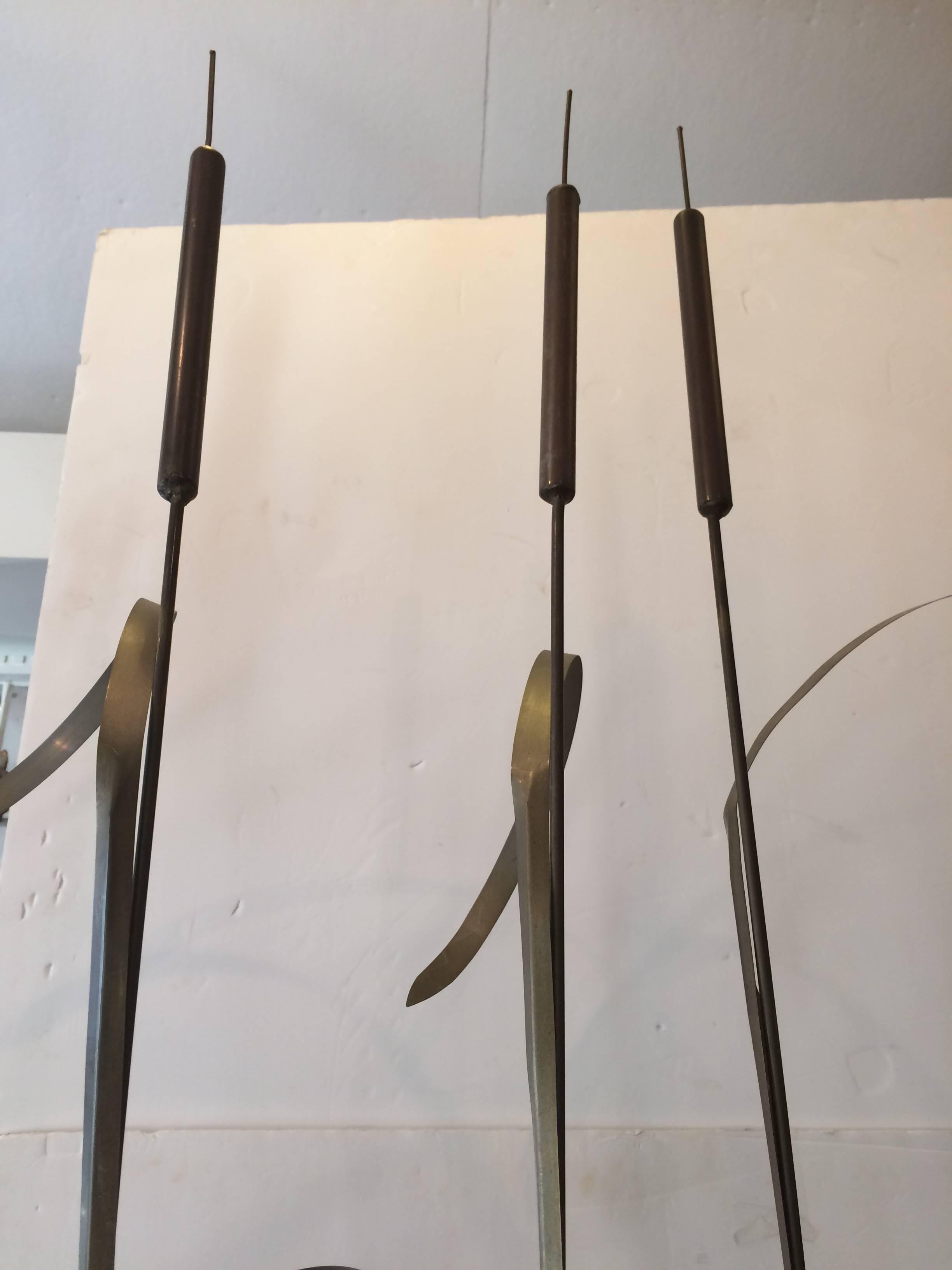 Very striking modern sculpture having three elongated brass stalks of wheat that stand upright in a sleek custom white marble base. One of a kind creation. Nice on the floor or up high on a console.