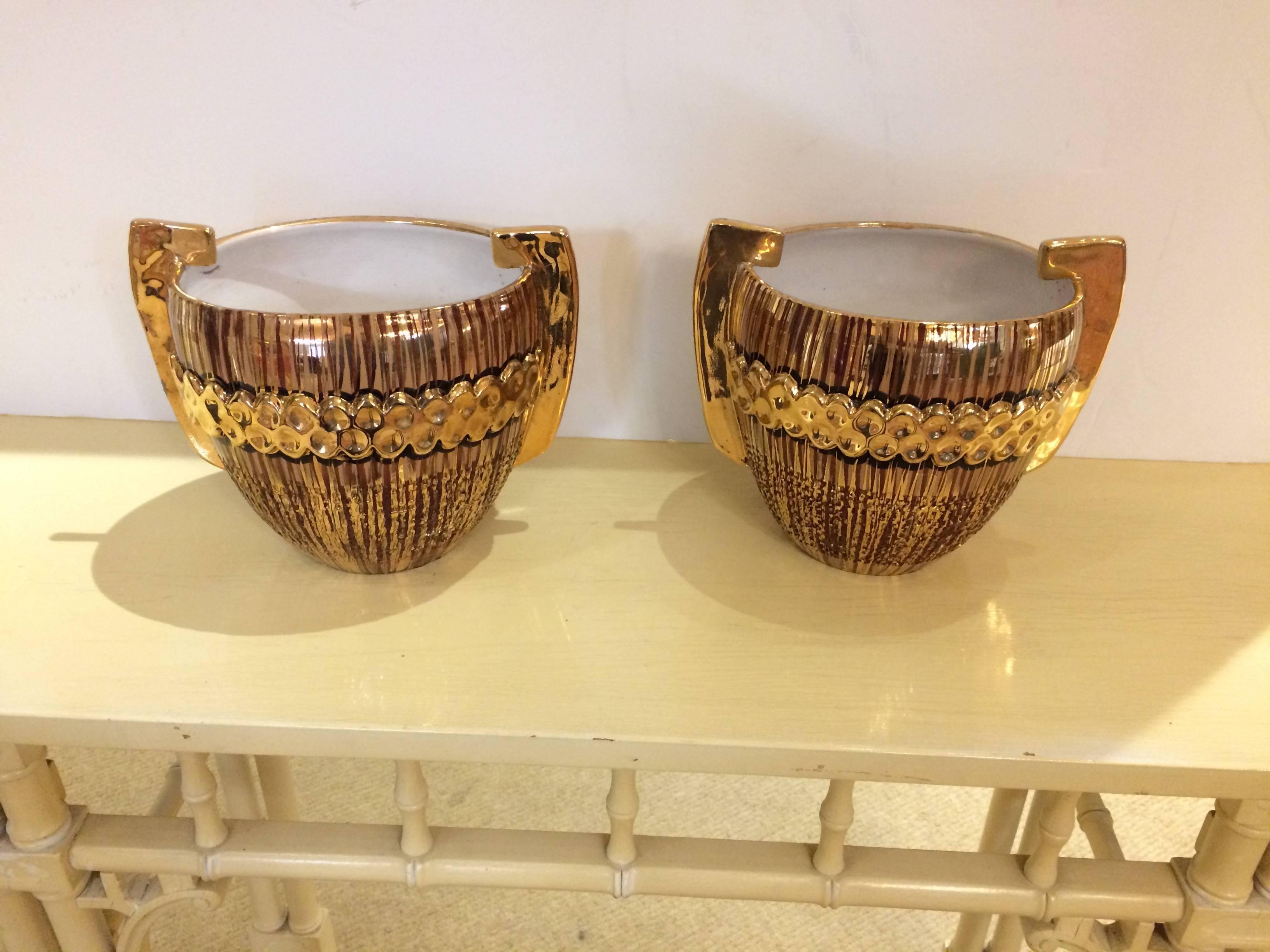 Two eye-catching Italian cachepots, planters, or beautiful accessory pottery having a glamorous gilded glaze and handles.