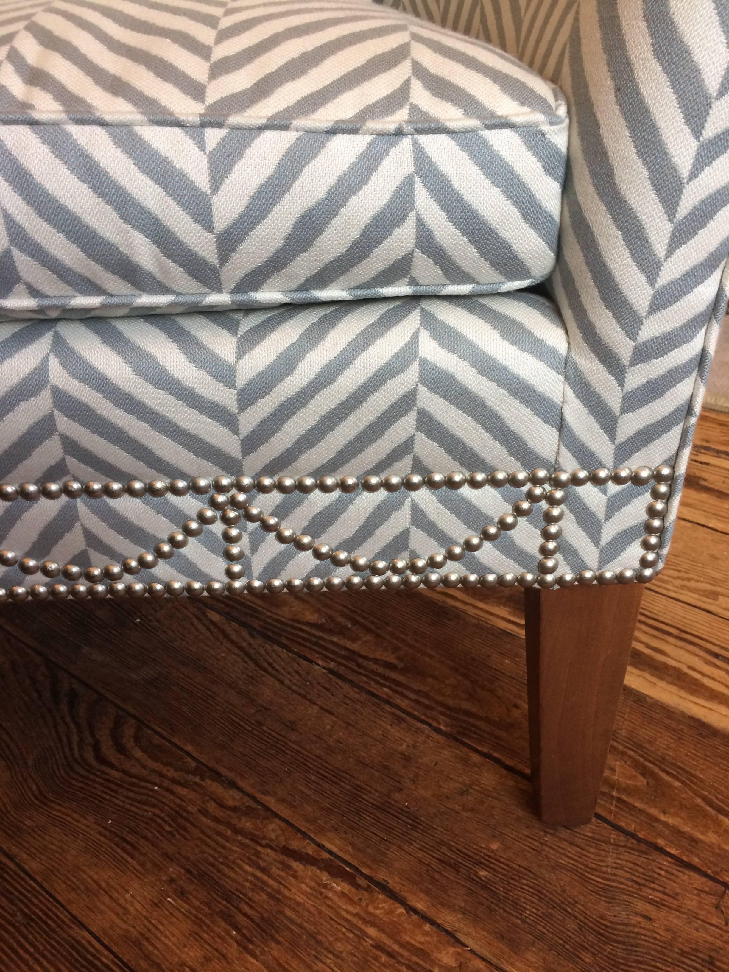 Sophisticated custom club chair having tailored lines, grey and white chevron upholstery and finished with nailheads. Cute little custom shaped back pillow included.
