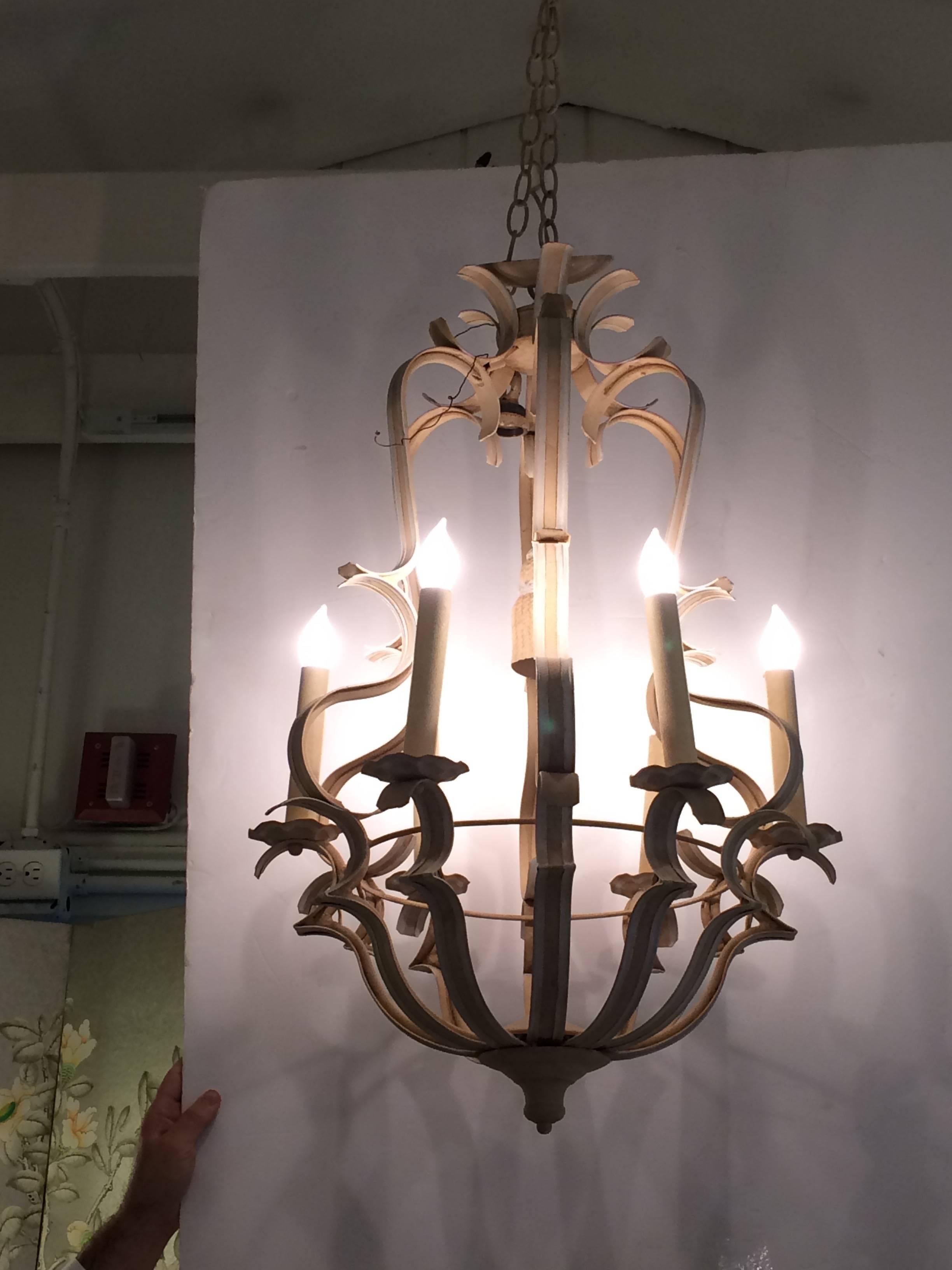 One of a kind custom fixture by Niermann Weeks having six arms (the one they usually make only has four), painted a two tone beige and cream tole and iron with a classy decorative iron tassel in the center. Parchment candle sleeves, matching canopy