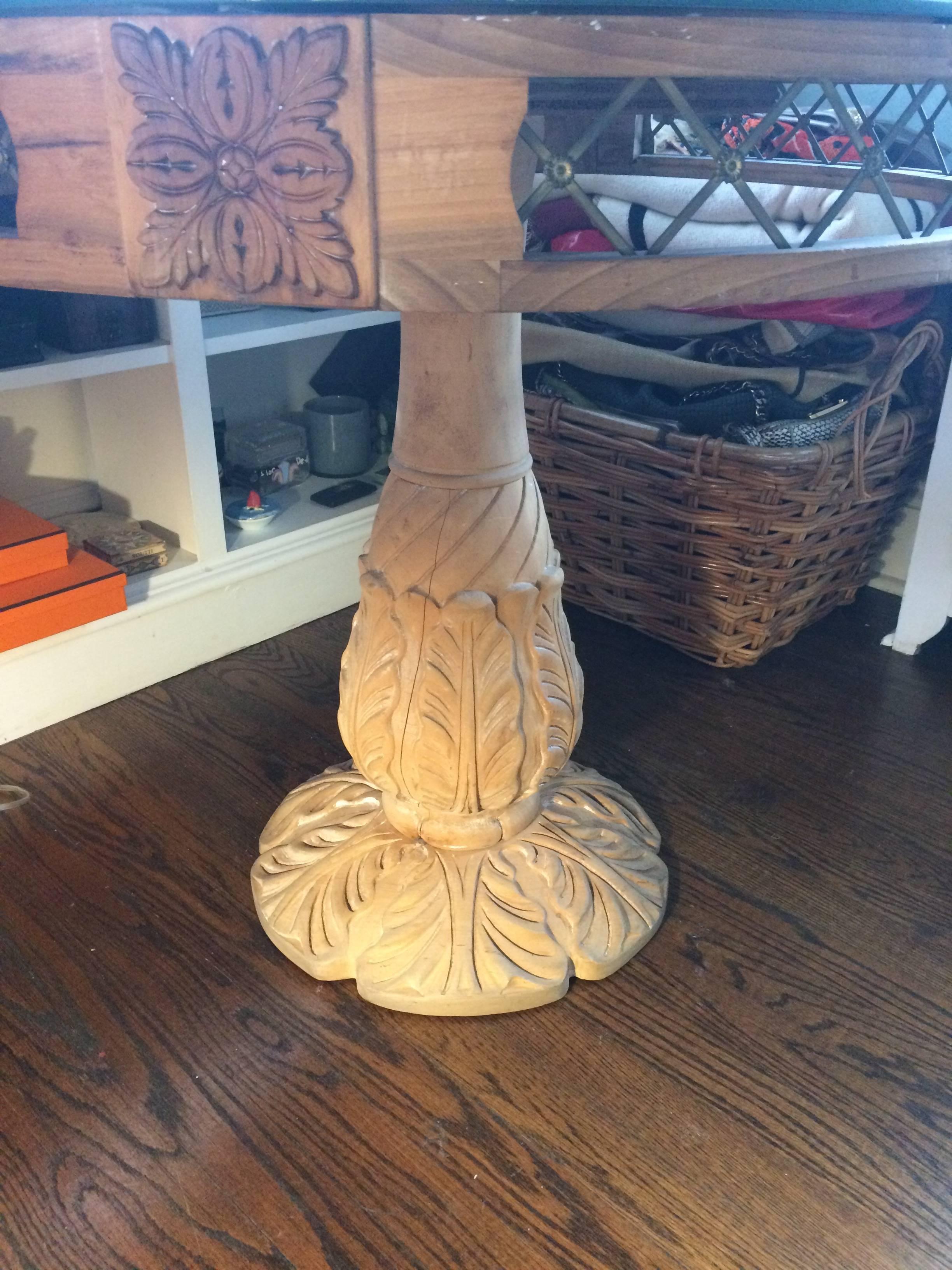 Medium sized natural carved wood pedestal round table having open decorative metal sections on the apron and very pretty acanthus leaf motife. Mirrored top.