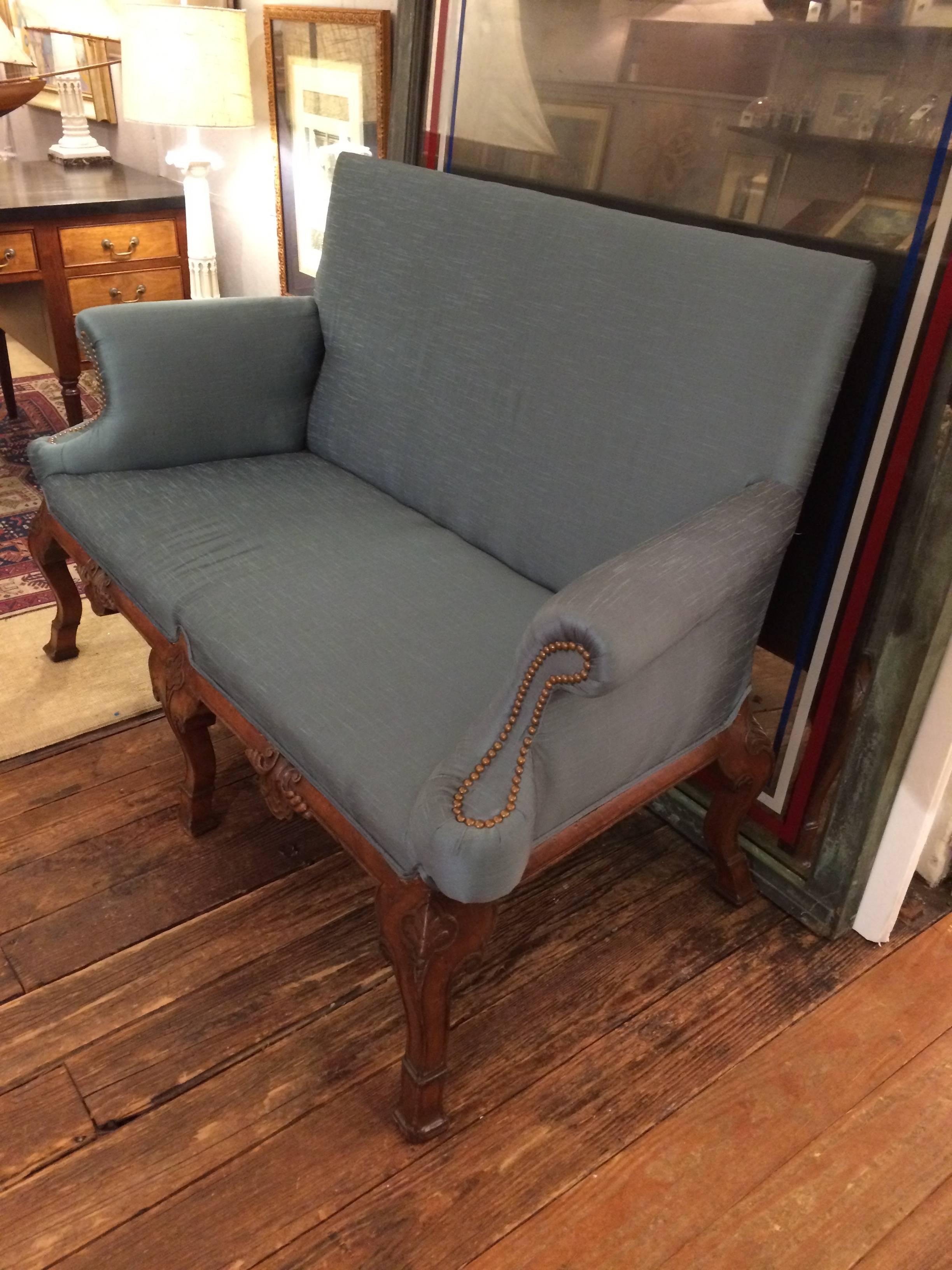 Beautiful carved wood antique loveseat having cabriole legs, acanthus leaf adornment, and blue natural silk upholstery.
Measure: Arm height 28.
