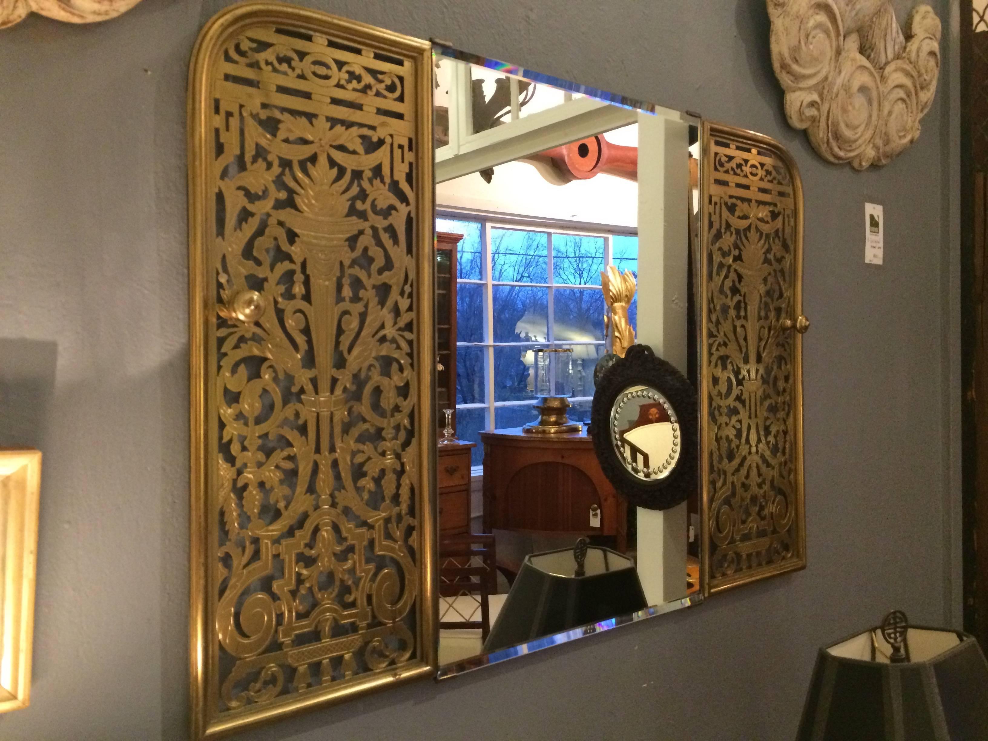 One of a kind mirror made from a beautifully cut-out brass fireplace fender.