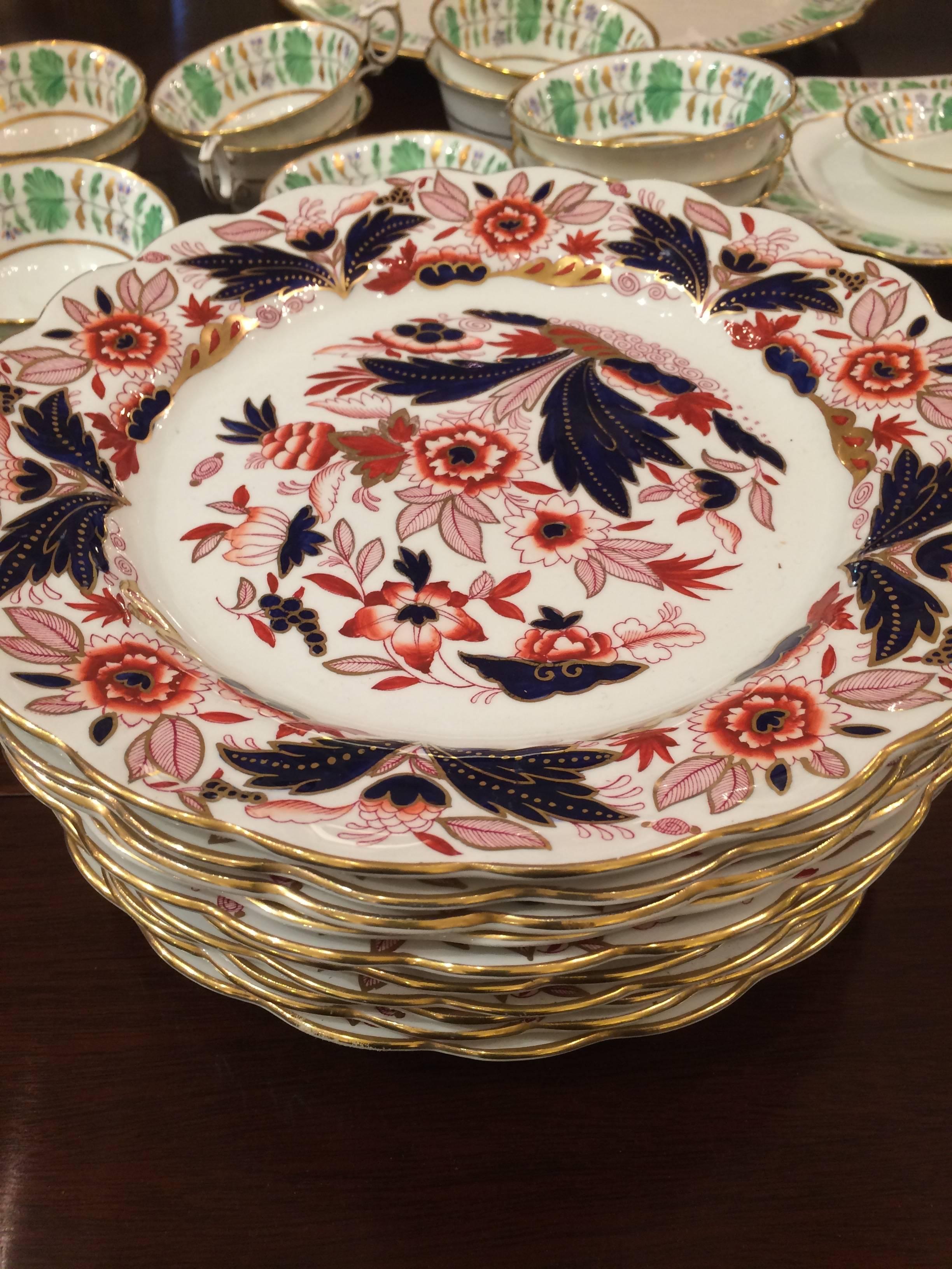 Magnificent Imari style English antique dinner plates in a gorgeous rich color palette of navy, red oxide and gold against a white background and having scallped edges.
Says Made In England, Booths Dovetail on reverse.
