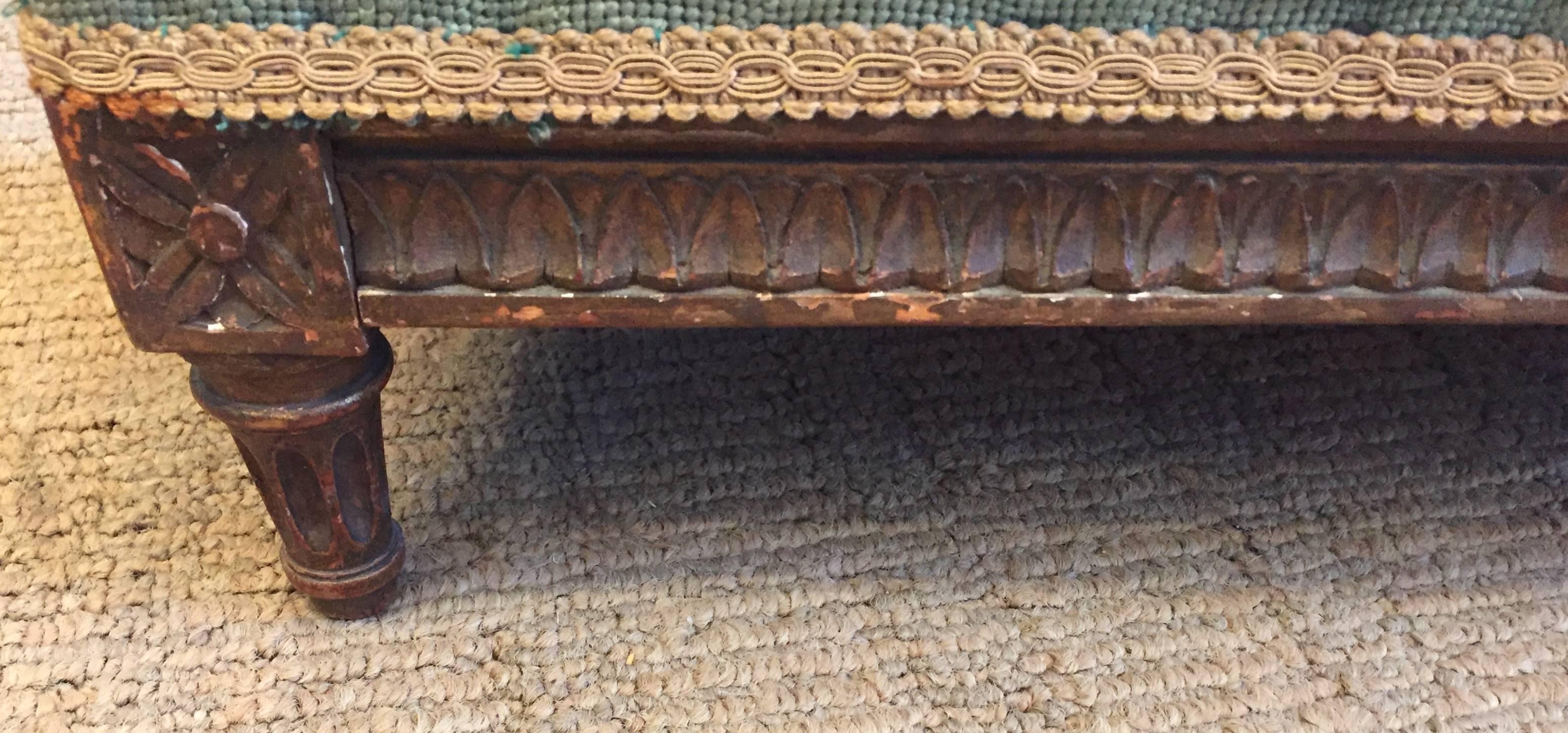 One of a kind gorgeous low narrow footstool or bench having a carved mahogany wood base with remnants of gold leafing and to die for original fabric with intricate hand done beadwork.