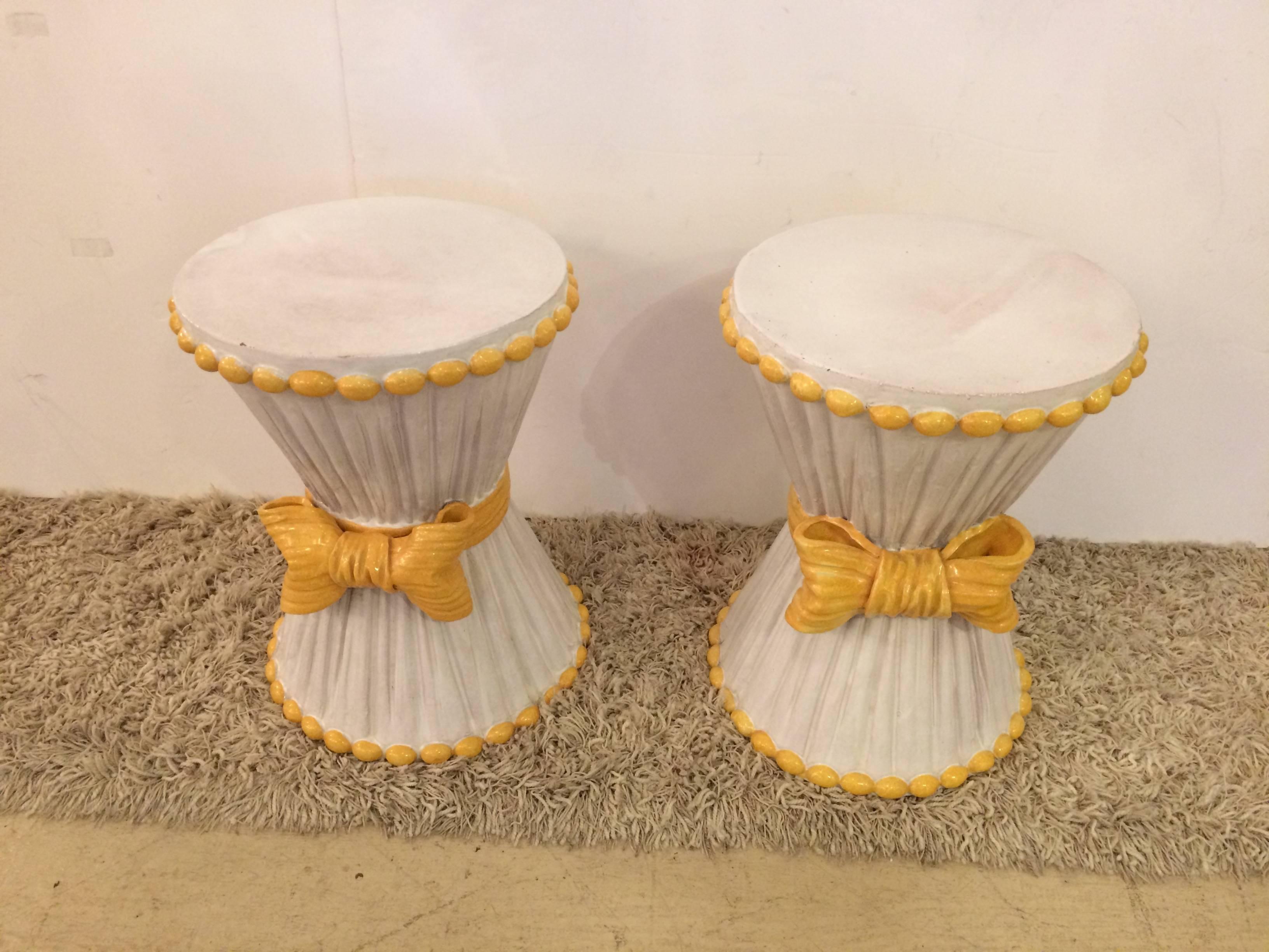 Two smashing cream colored midcentury Italian terra-cotta garden seats or occasional tables in hourglass shapes and adorable Provencal yellow details and bows on the front.