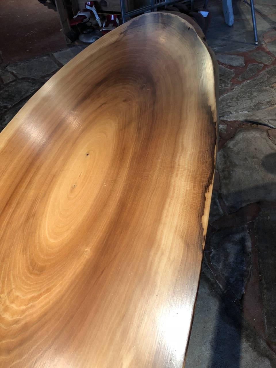 Very cool handmade slab of gorgeous poplar in the shape of a surfboard, fashioned into a modern coffee table with iron industrial machine legs.