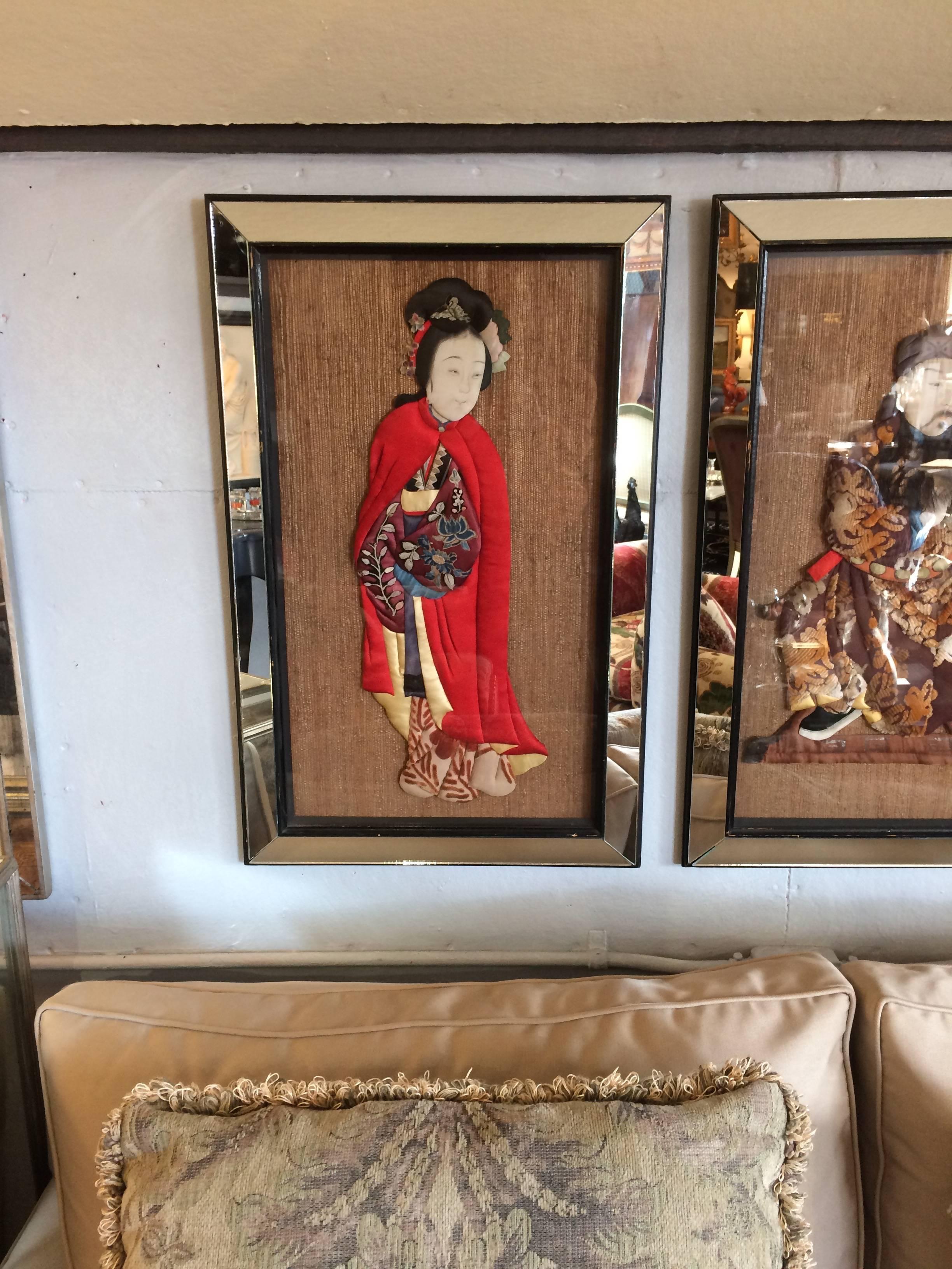 A wonderfully colorful and meticulously hand crafted set of 4 quilted Asian figures with amazing mixed textiles, each framed handsomely against a natural grasscloth with glamorous mirrored frames.