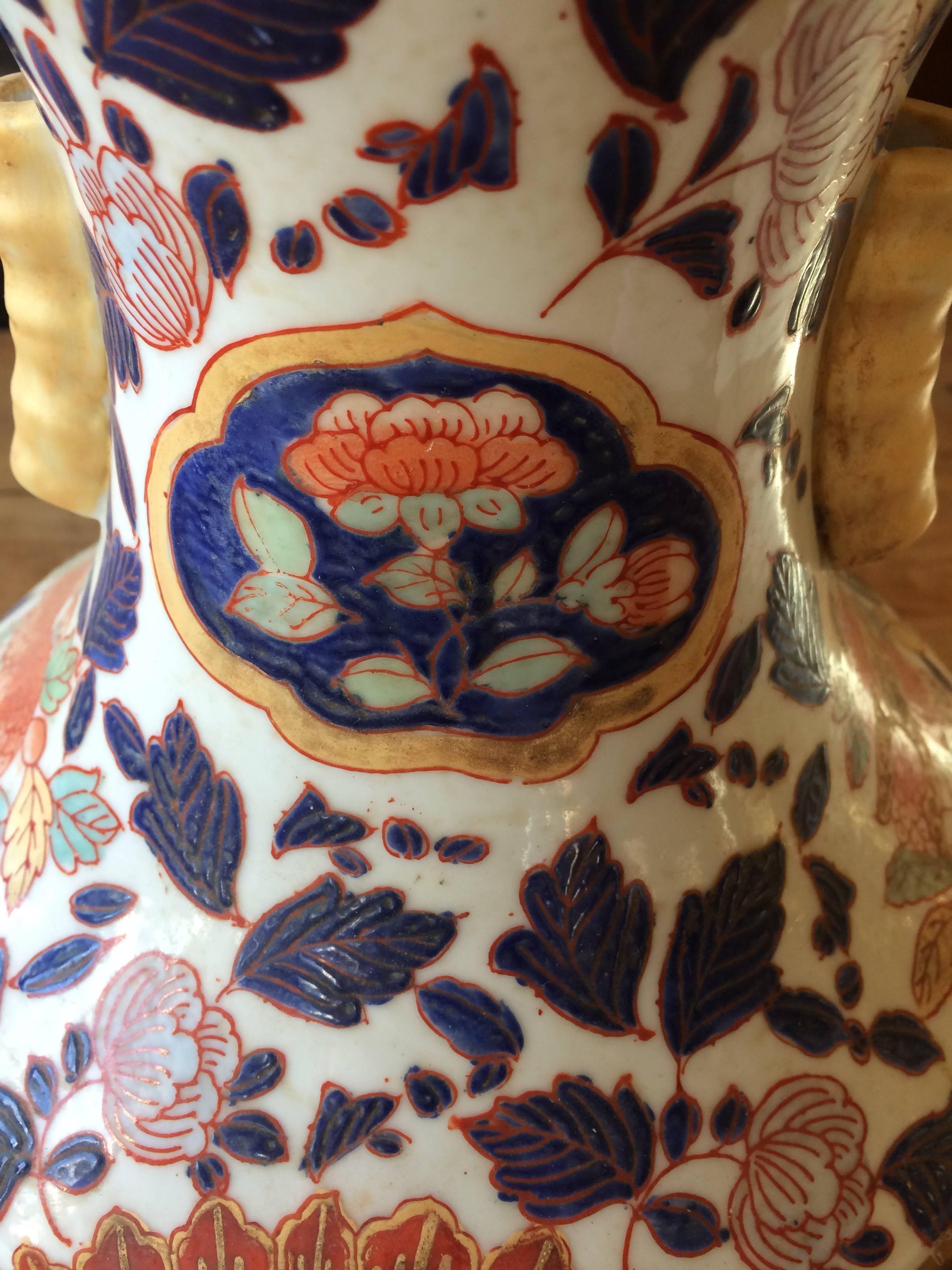 Lovely pair of Chinese Imari vases or urns in blue, orange and white. Measure: Opening at top 5.25.