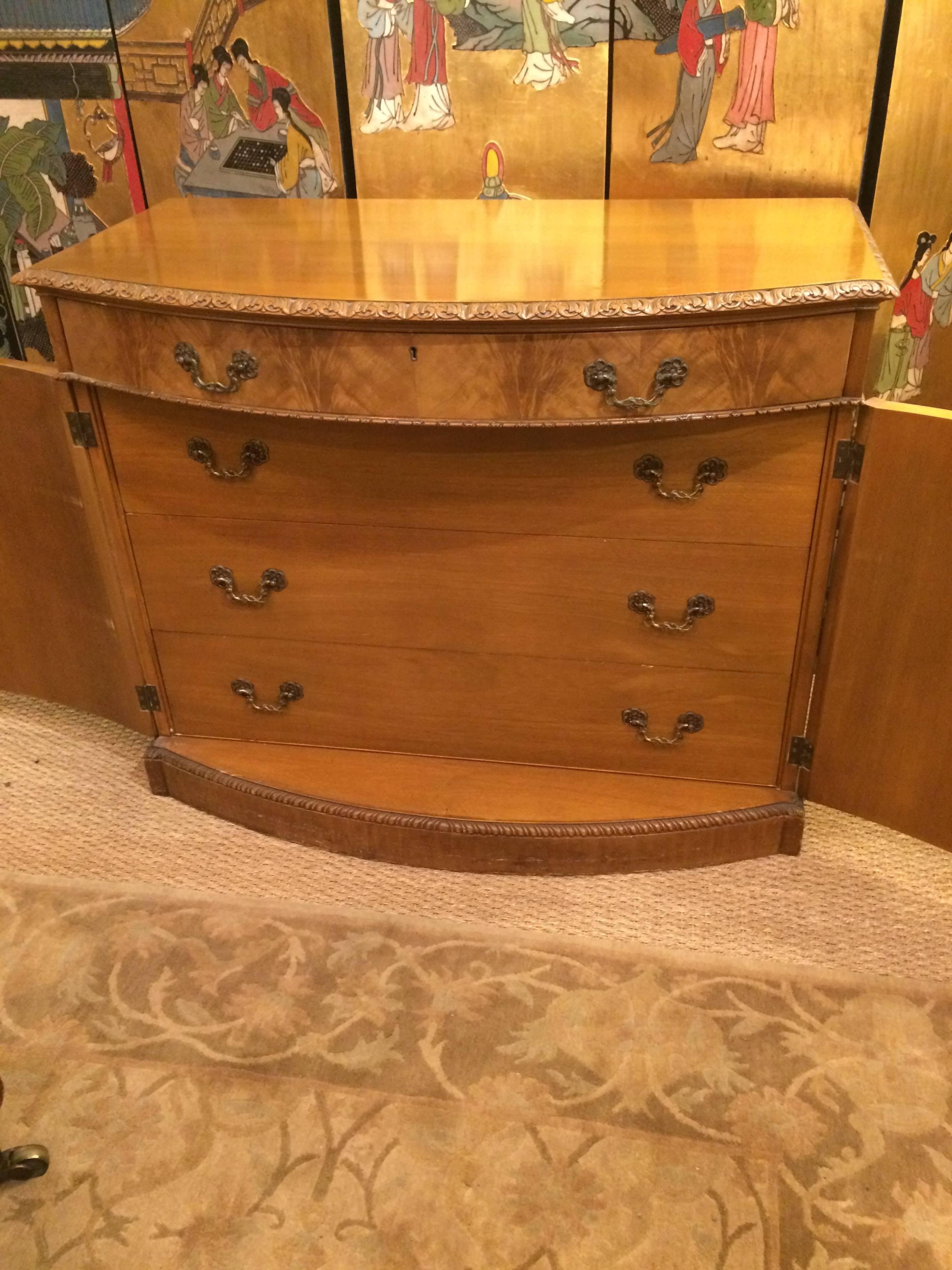 Gorgeous cabinet chest of drawers having one top drawer and beautiful front panel doors that open to reveal three drawers inside. Original hardware and key. Magnificent grain on the doors.