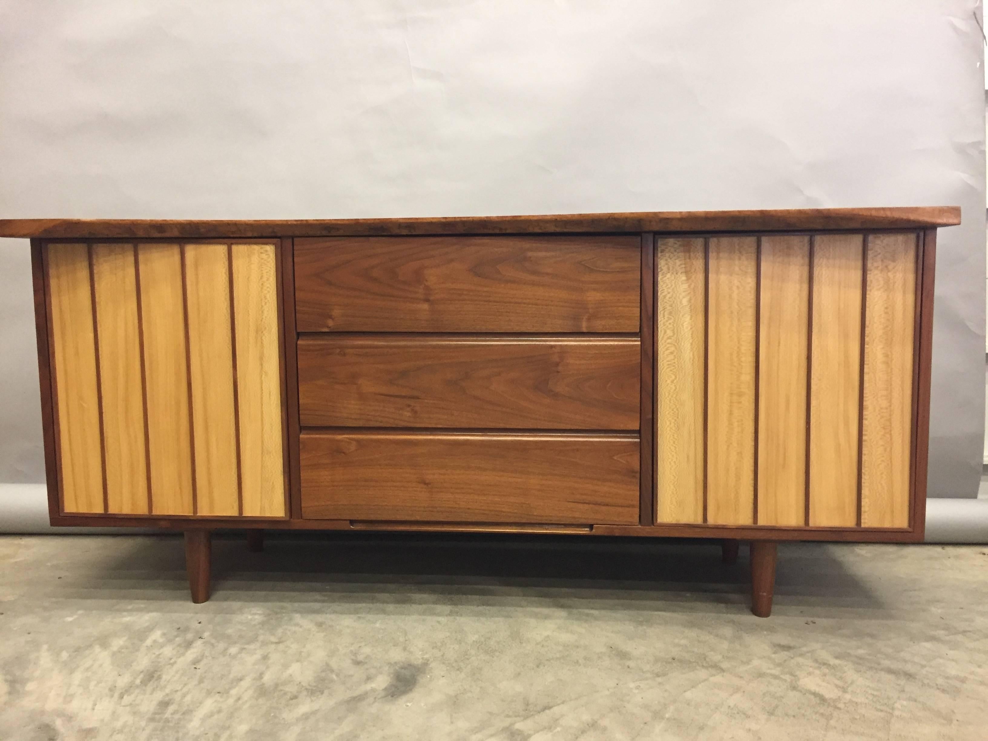 Nakashima style handmade mixed wood credenza cabinet having an organic irregular gorgeous slab of wood for the top, and below, two panels of a different kind of wood that open to reveal storage, as well as three spacious drawers, all dovetailed and