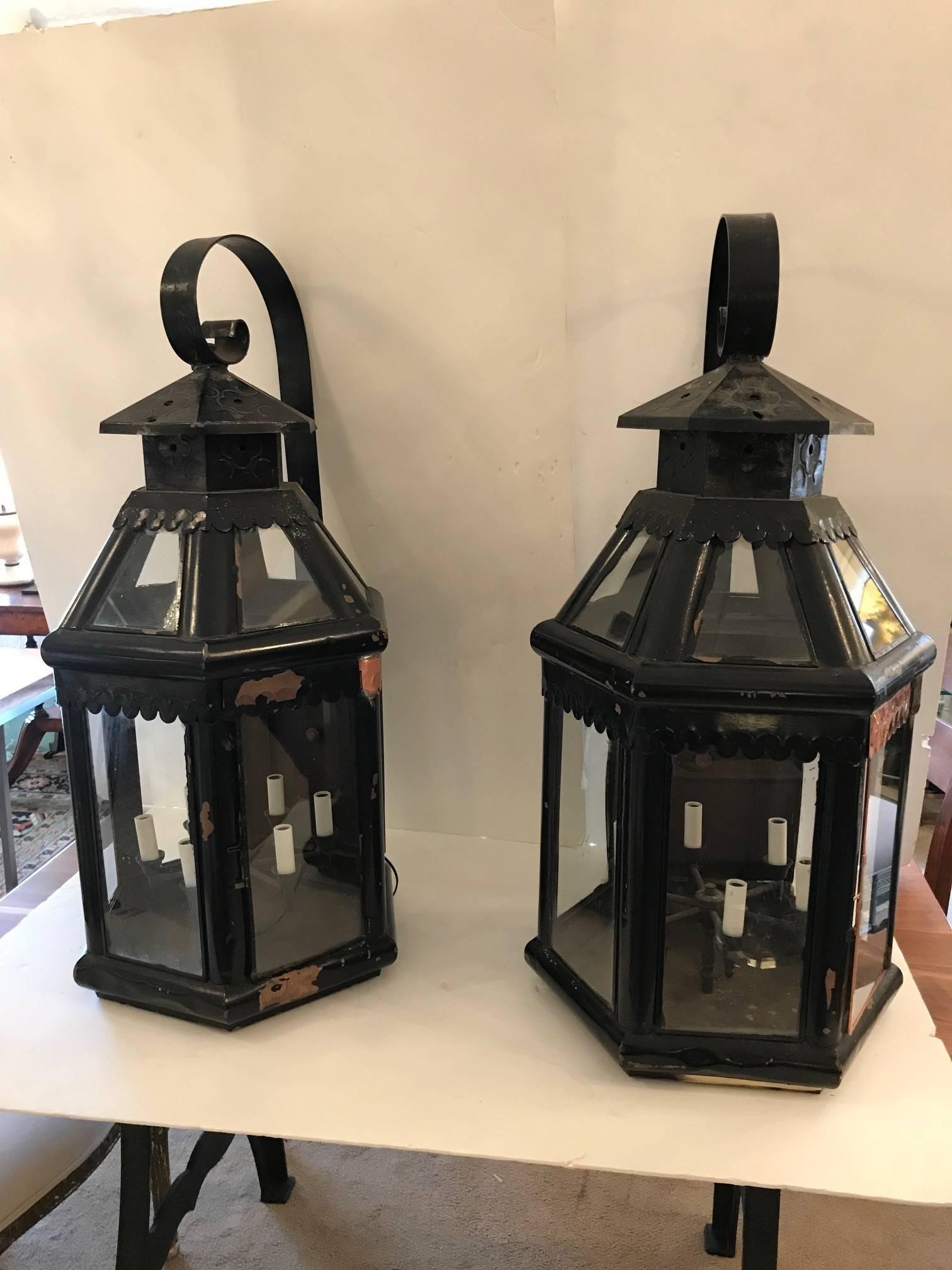 Rare pair of huge vintage copper lanterns painted black with some of the copper visible, having six lights inside the multi sided glass houses, newly rewired.
 