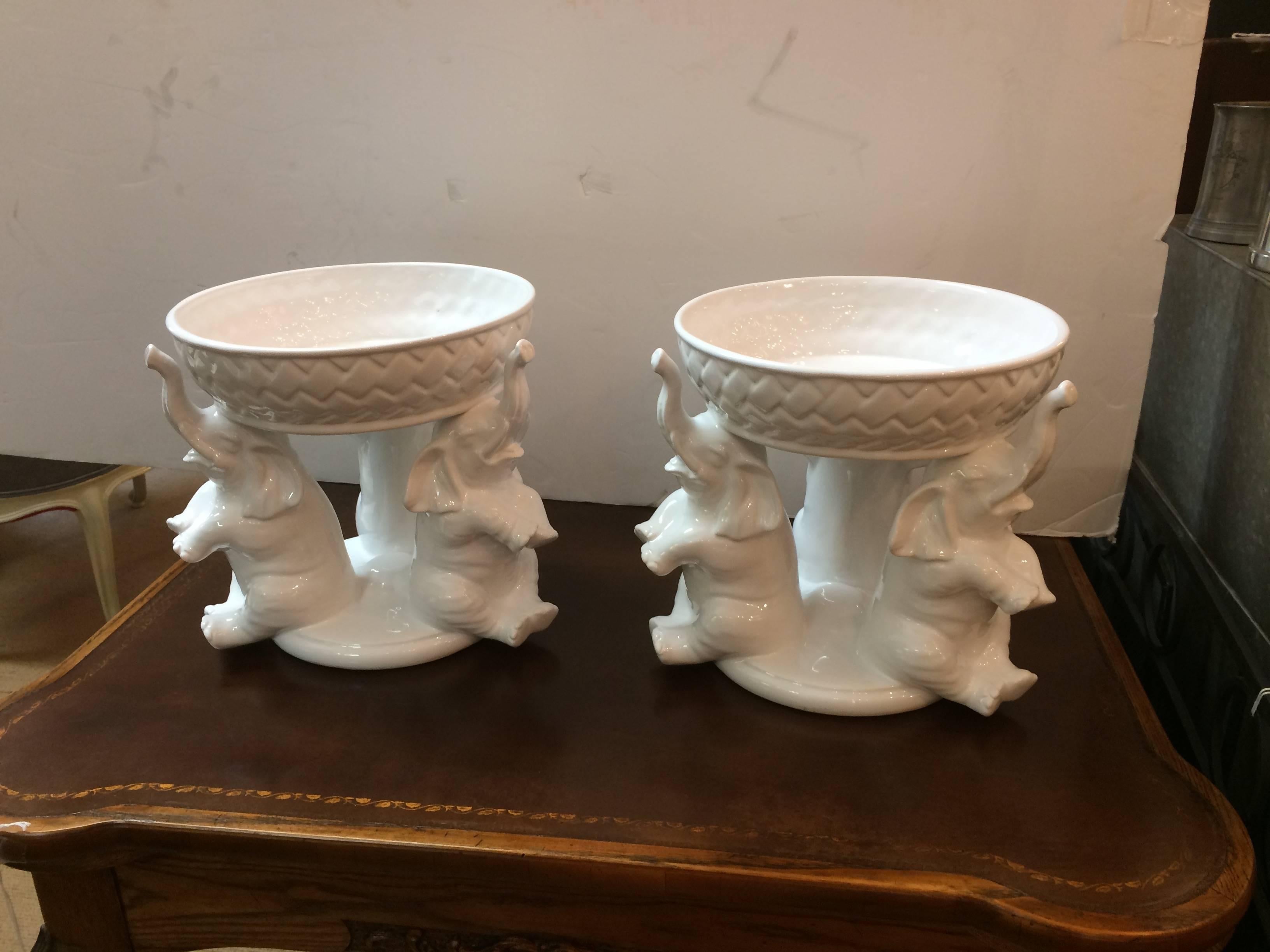 Wonderfully designed pair of circular accessories or centrepieces having bases with three elephants with raised trunks that support the bowls above.